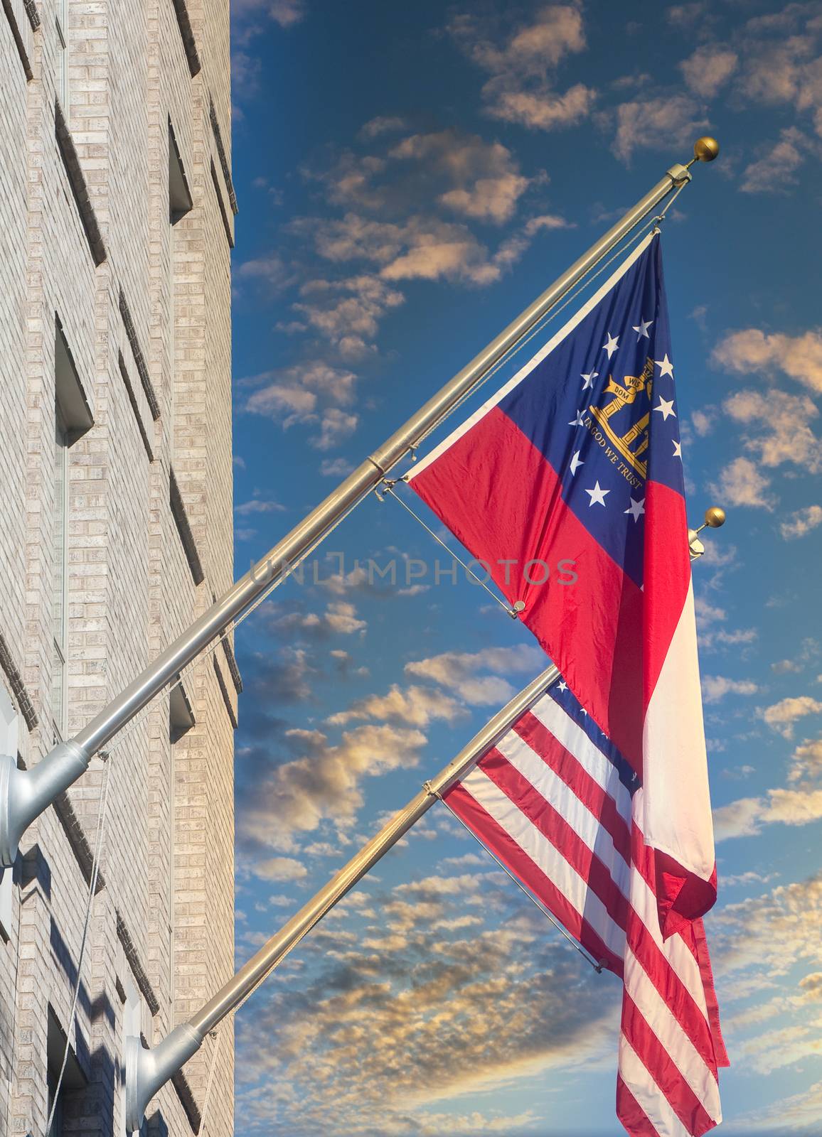Flags of America and the state of Georgia on poles on a building