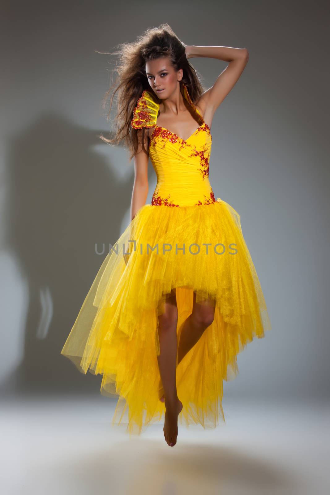 Young beautiful woman in a wedding dress on a studio background