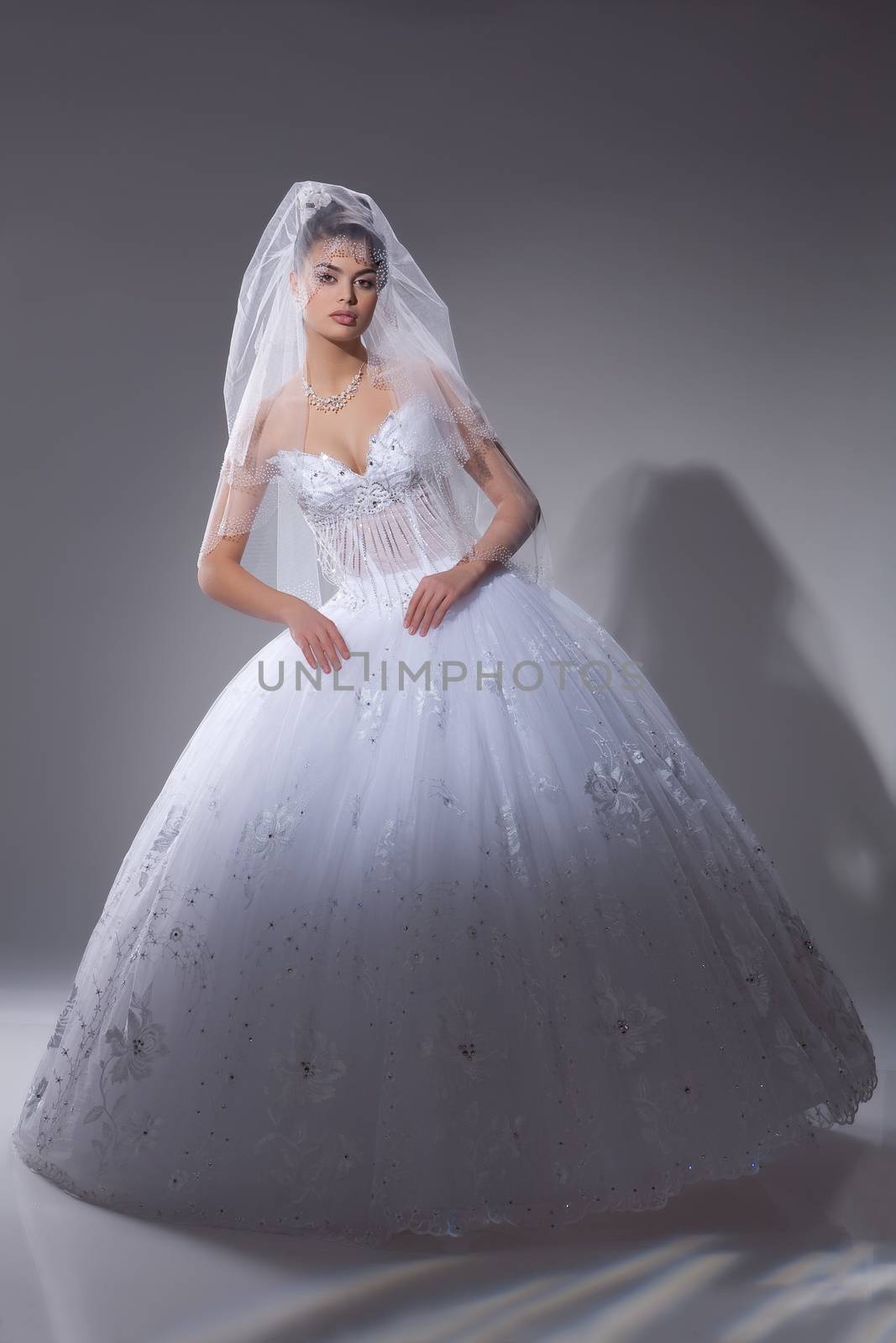 Young beautiful dark-haired woman in a wedding fashionable dress