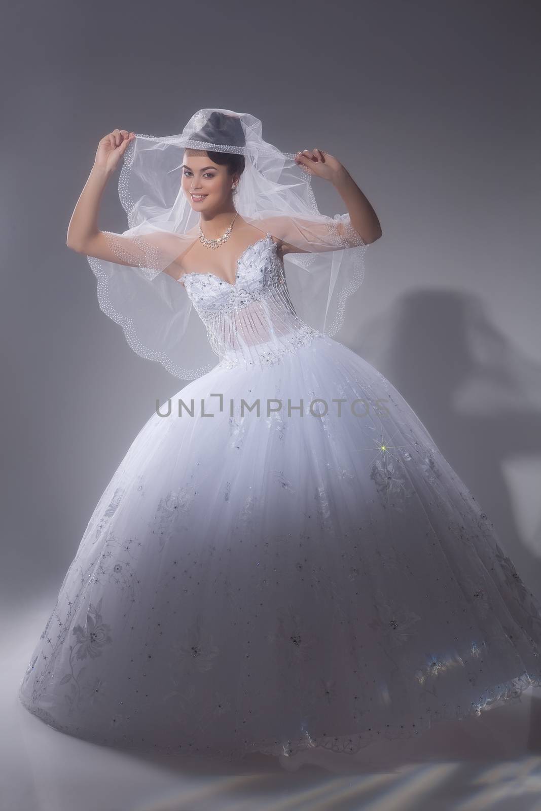 Young beautiful dark-haired woman in a wedding fashionable dress