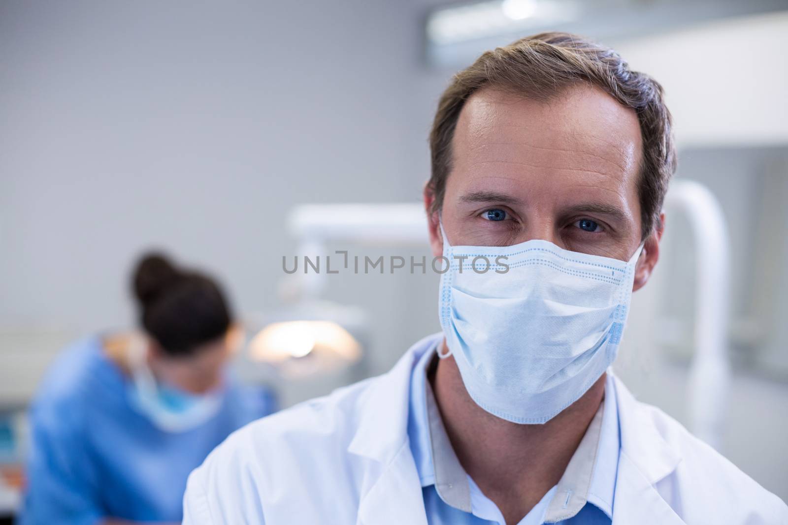Portrait of dentist wearing surgical mask in dental clinic