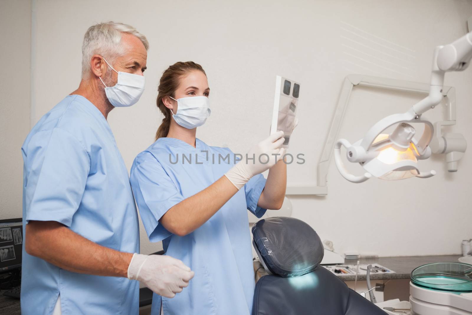 Dentist and assistant studying x-rays by Wavebreakmedia