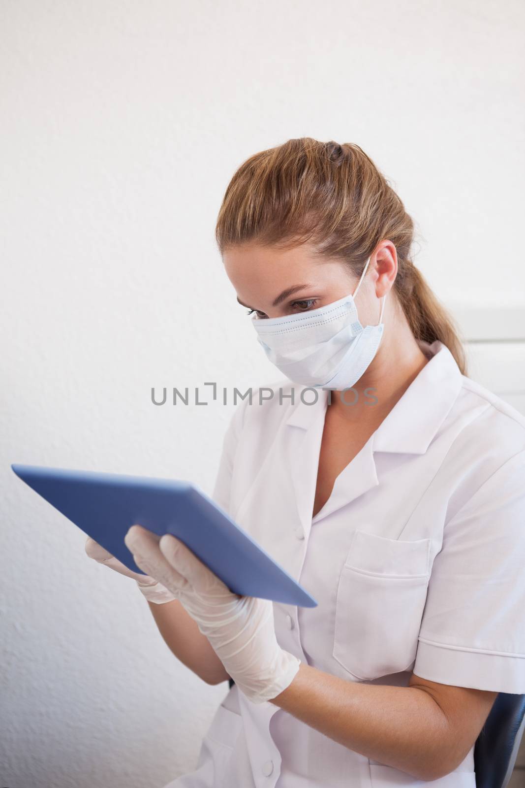 Dental assistant working on tablet pc by Wavebreakmedia