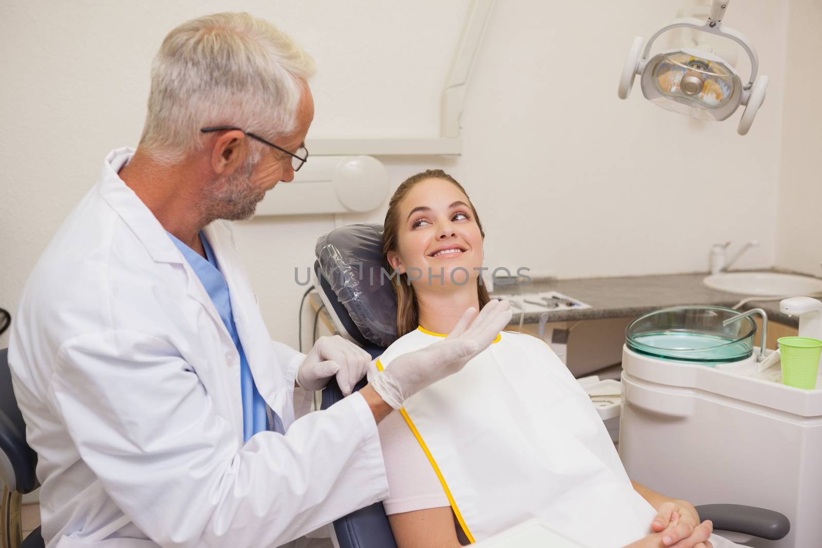 Dentist speaking with patient in the chair at the dental clinic