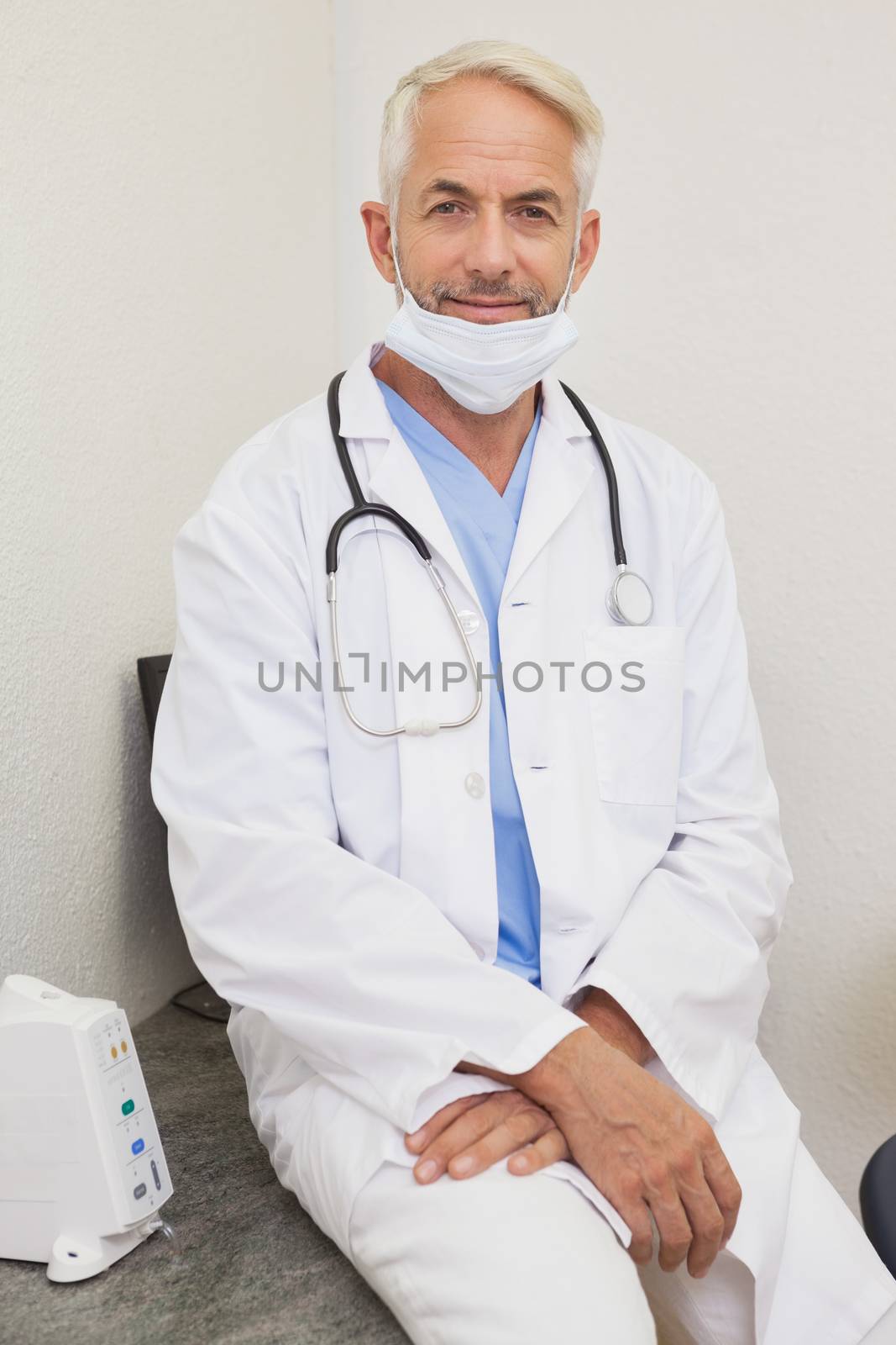Dentist smiling at camera in lab coat by Wavebreakmedia
