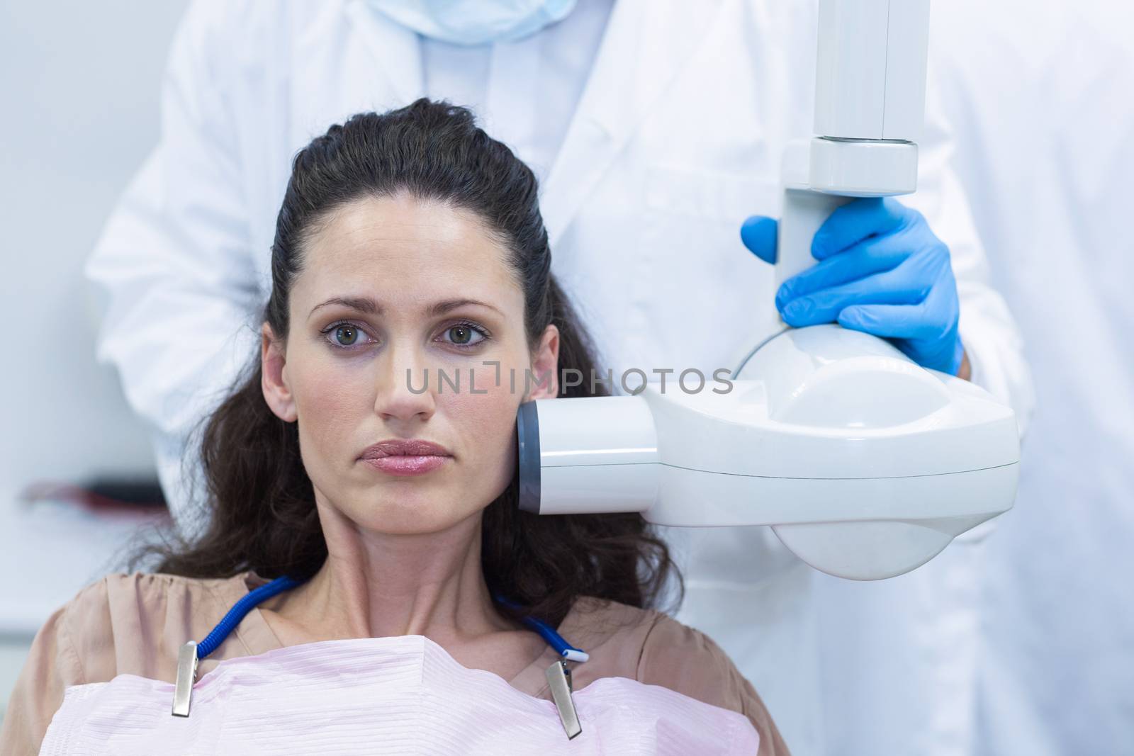 Dentist taking x-ray of patients teeth at dental clinic