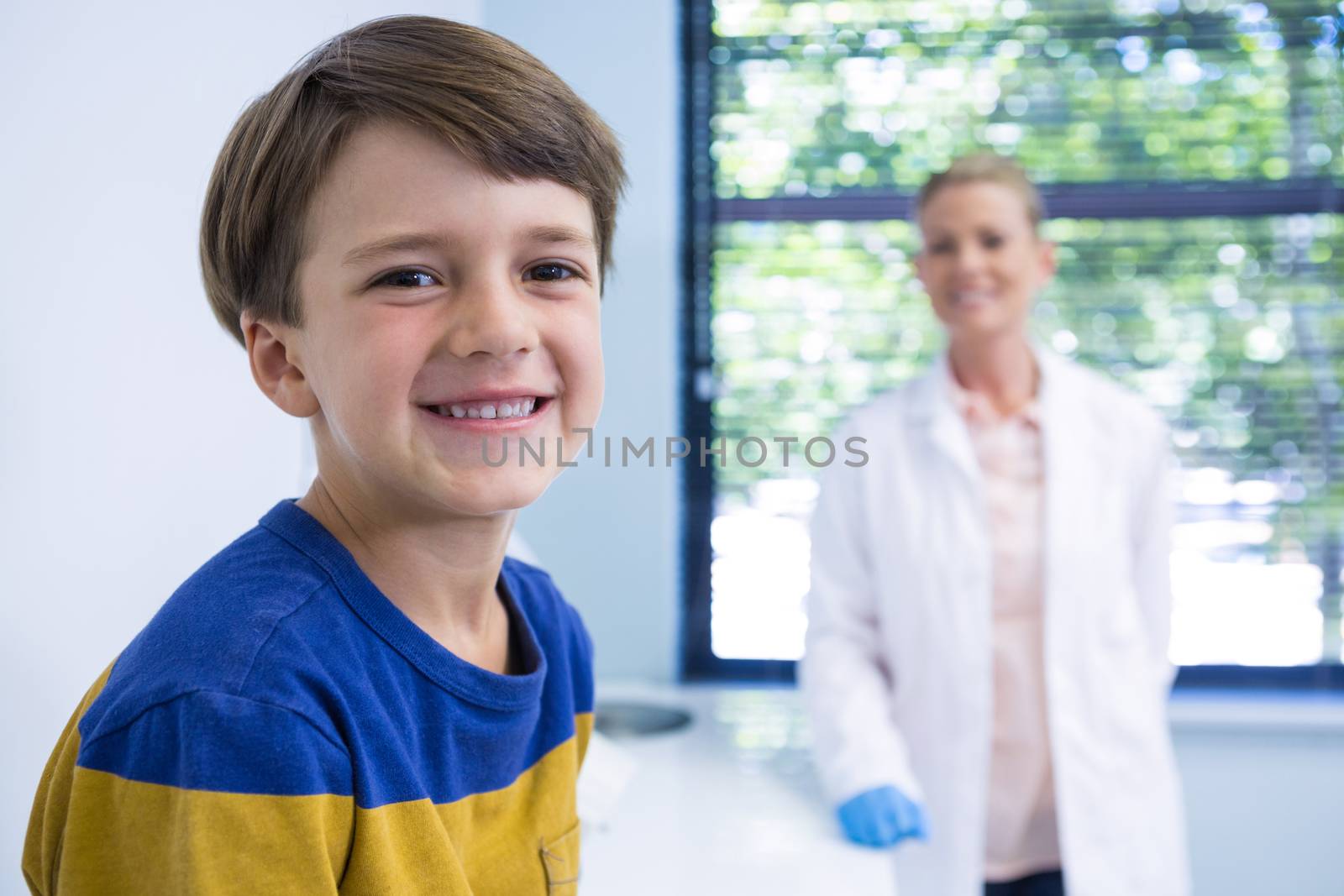 Portrait of smiling boy and dentist at medical clinic