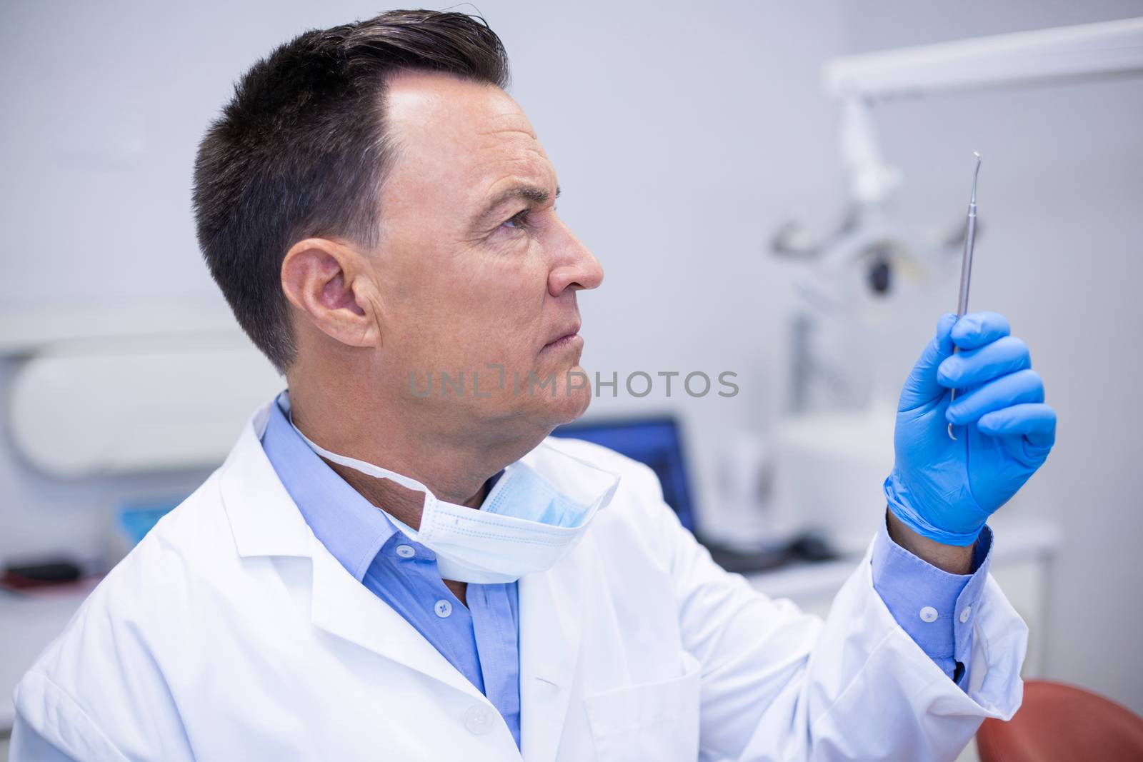 Dentist checking tools in dental clinic by Wavebreakmedia