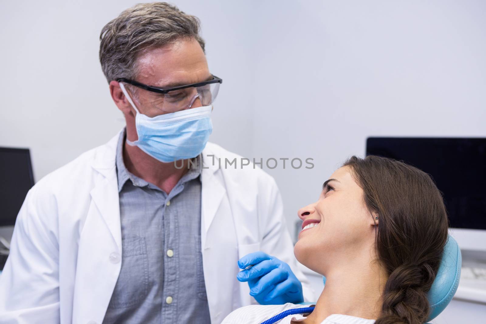 Dentist talking with woman at medical clinic