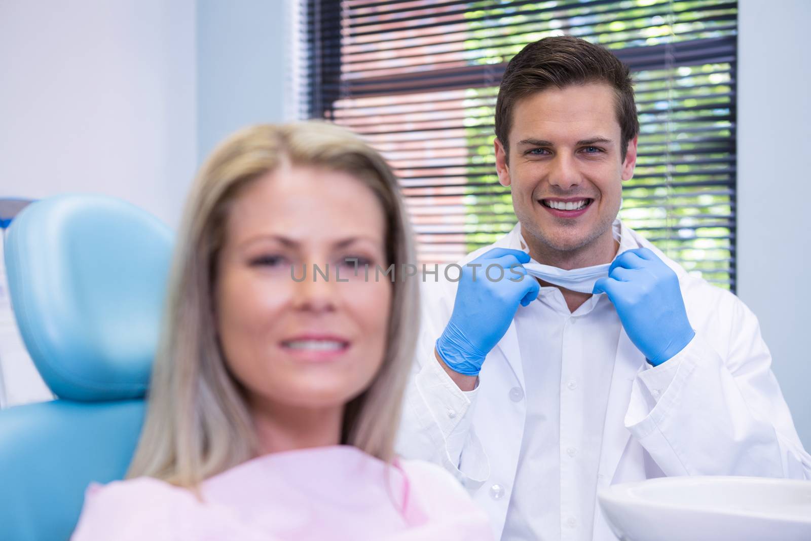 Happy patient and dentist  at dental clinic by Wavebreakmedia