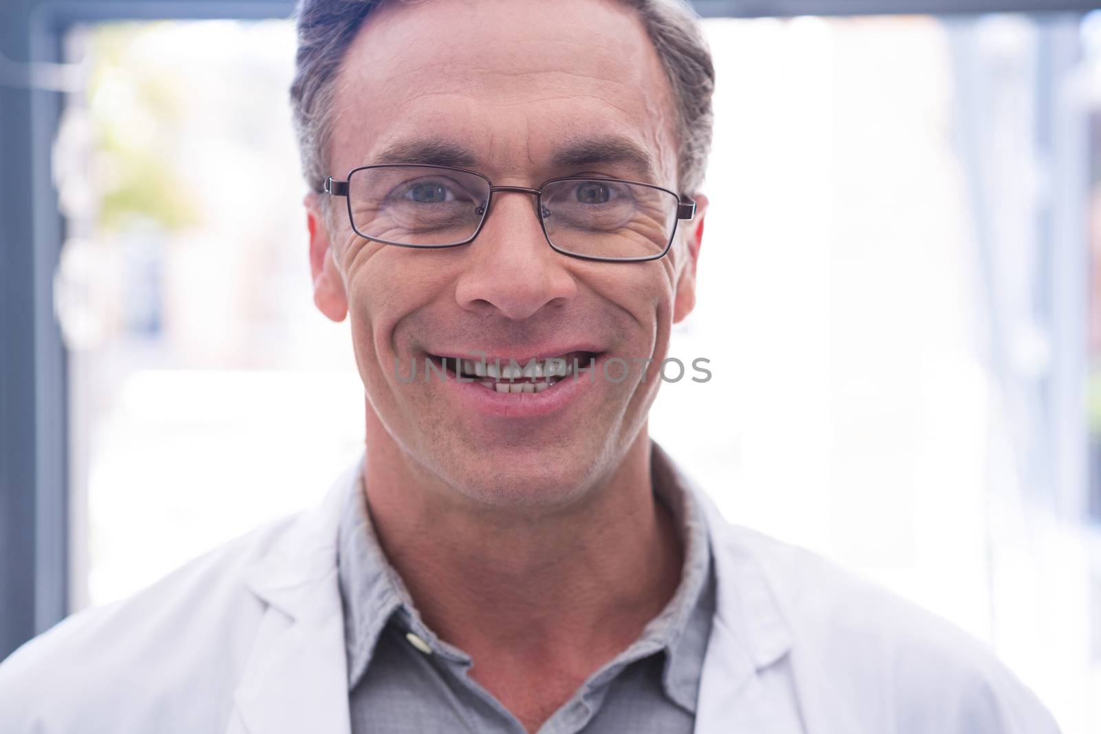 Portrait of smiling dentist with eyeglasses by Wavebreakmedia