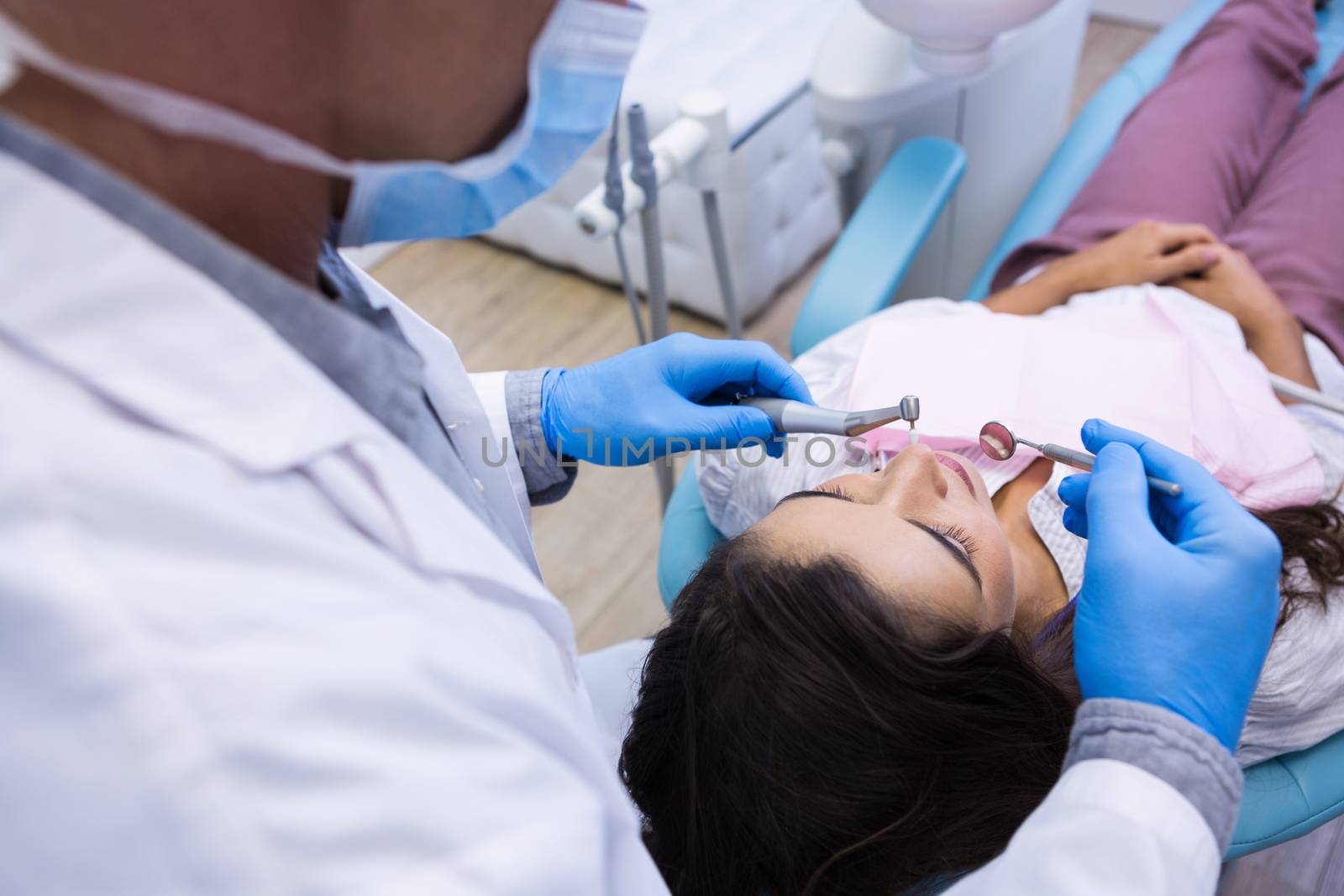 Close up of dentist examining woman mouth by Wavebreakmedia