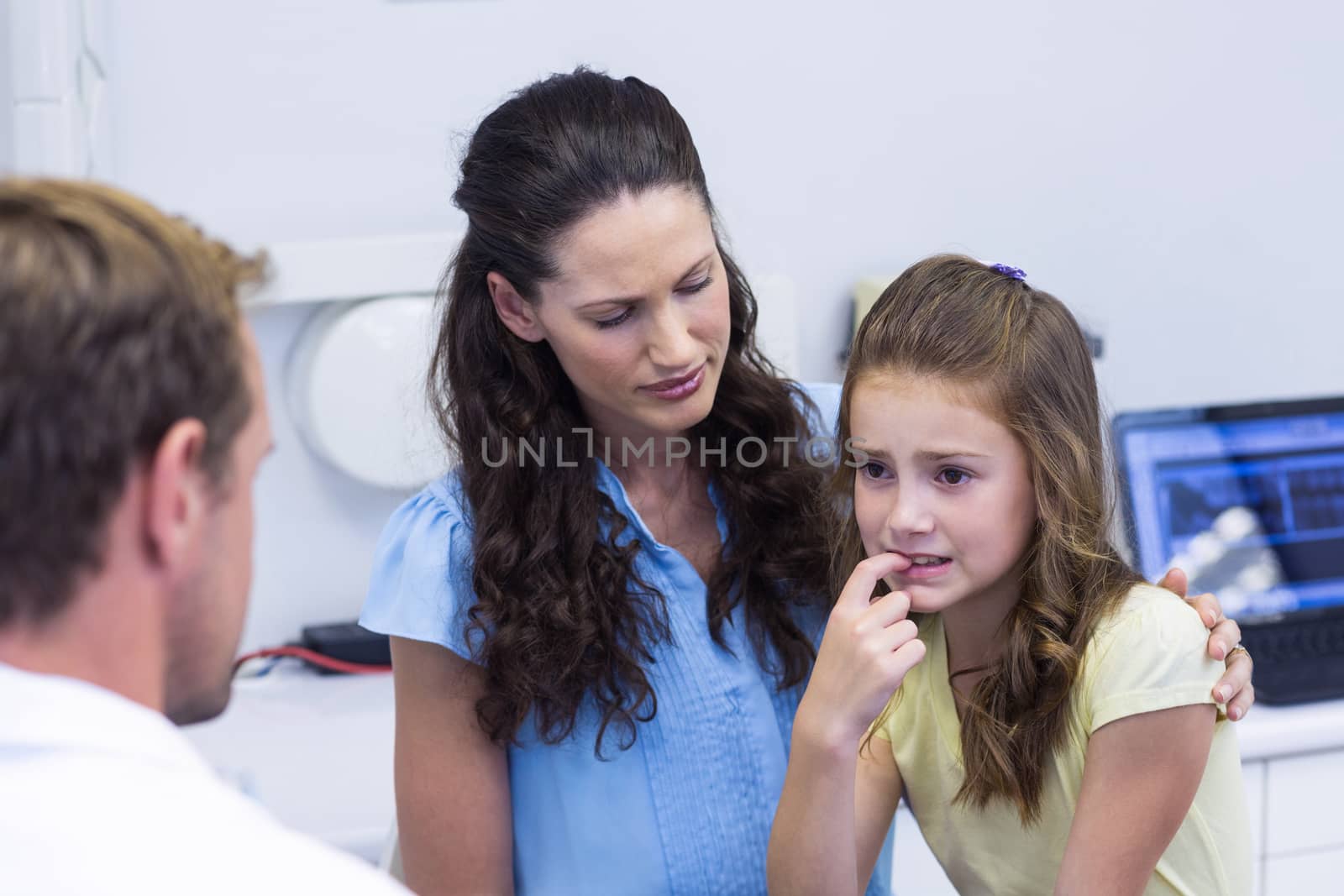 Young patient showing teeth to dentist by Wavebreakmedia