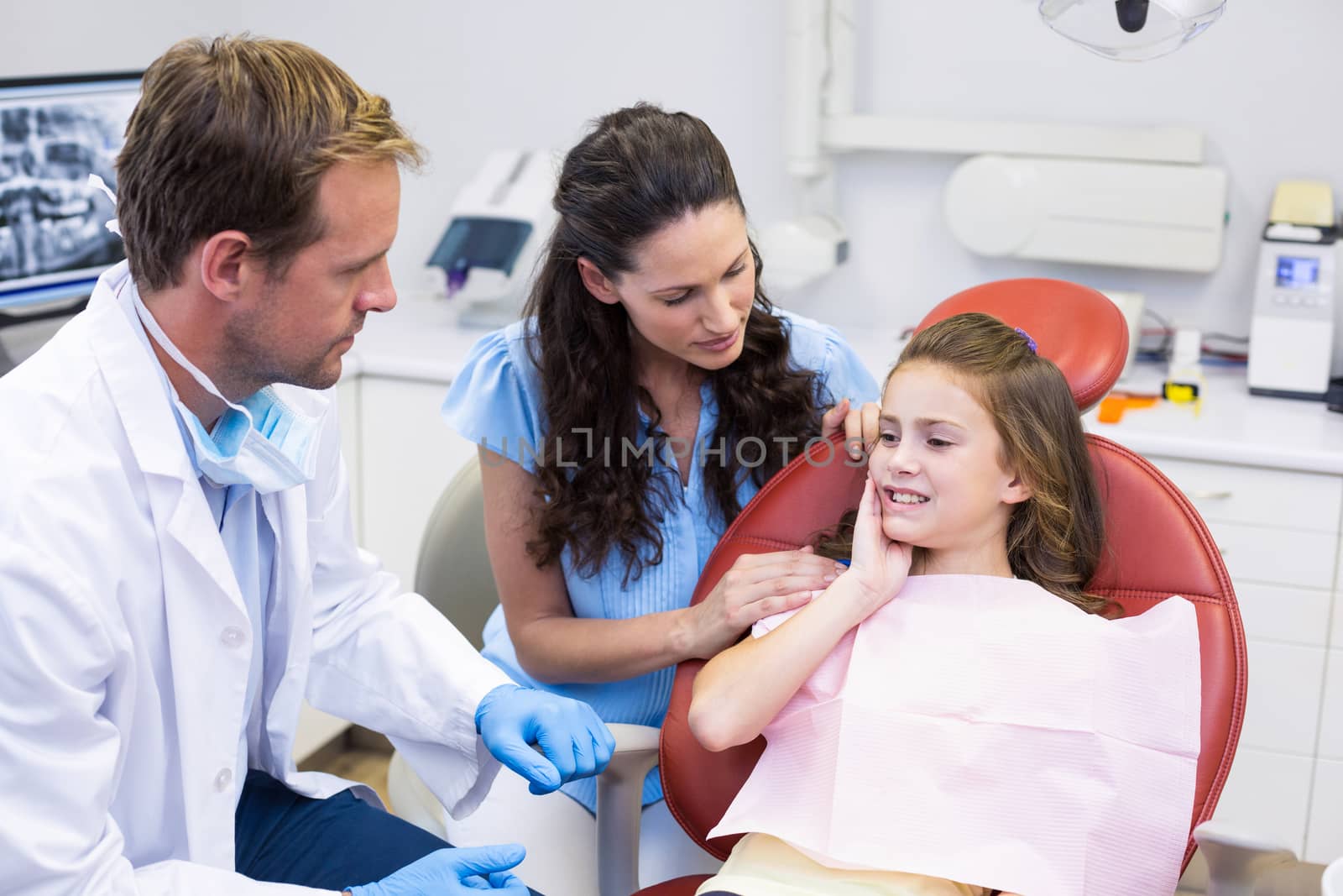 Young patient showing teeth to dentist in dental clinic