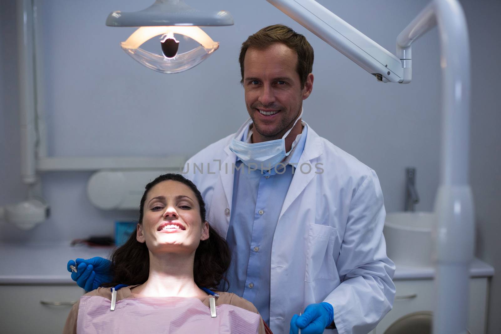 Portrait of smiling dentists and young patient by Wavebreakmedia