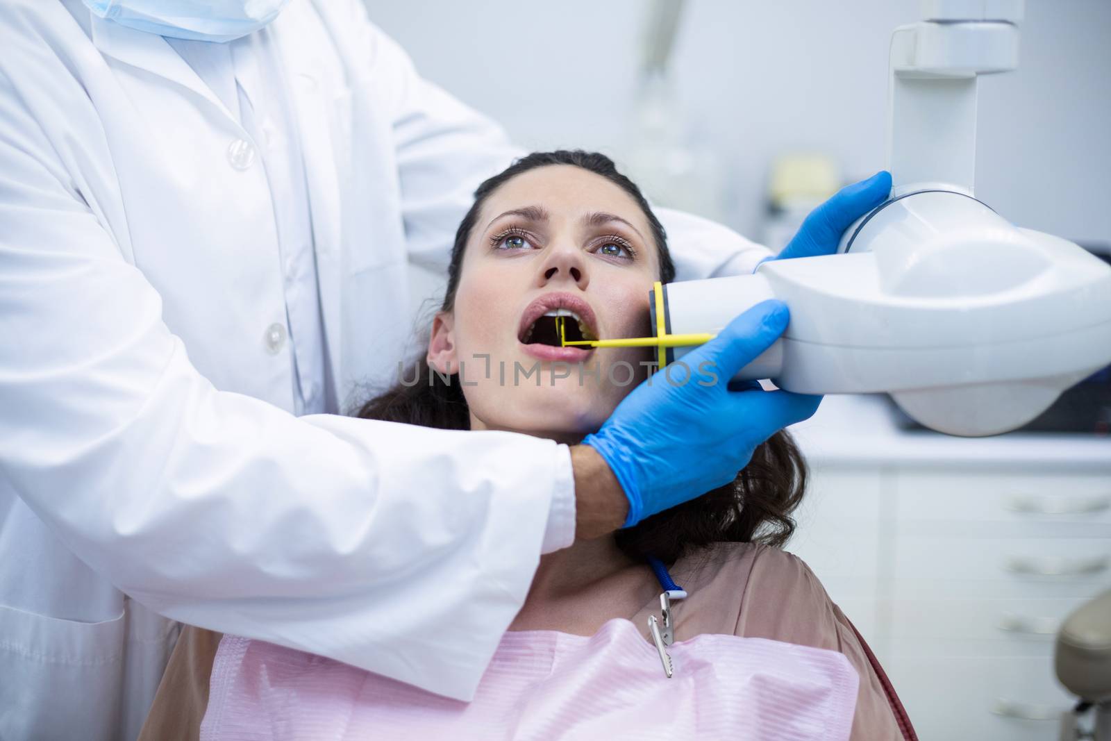 Dentist taking x-ray of patients teeth by Wavebreakmedia
