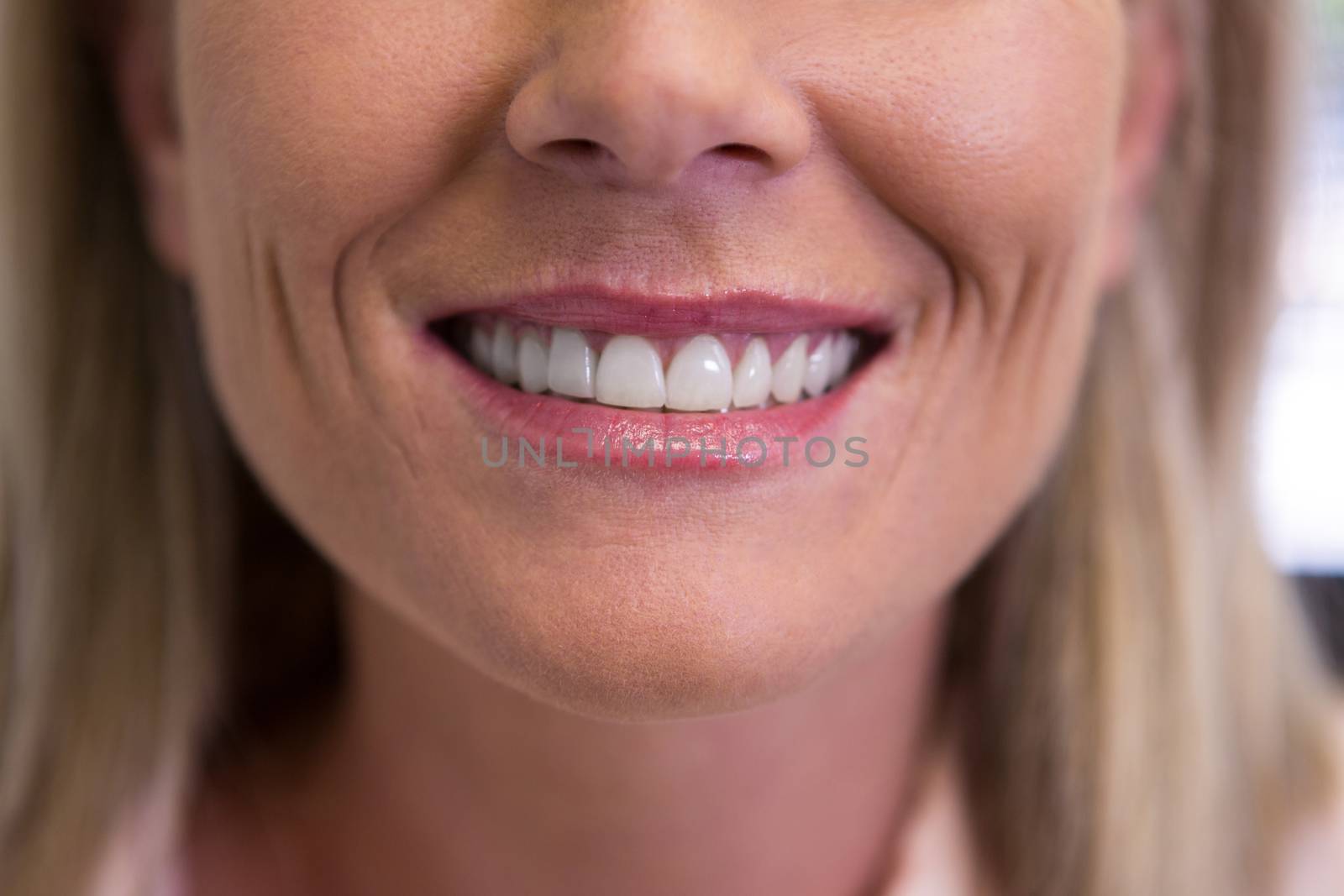 Closeup of beautiful woman smiling at dentist office