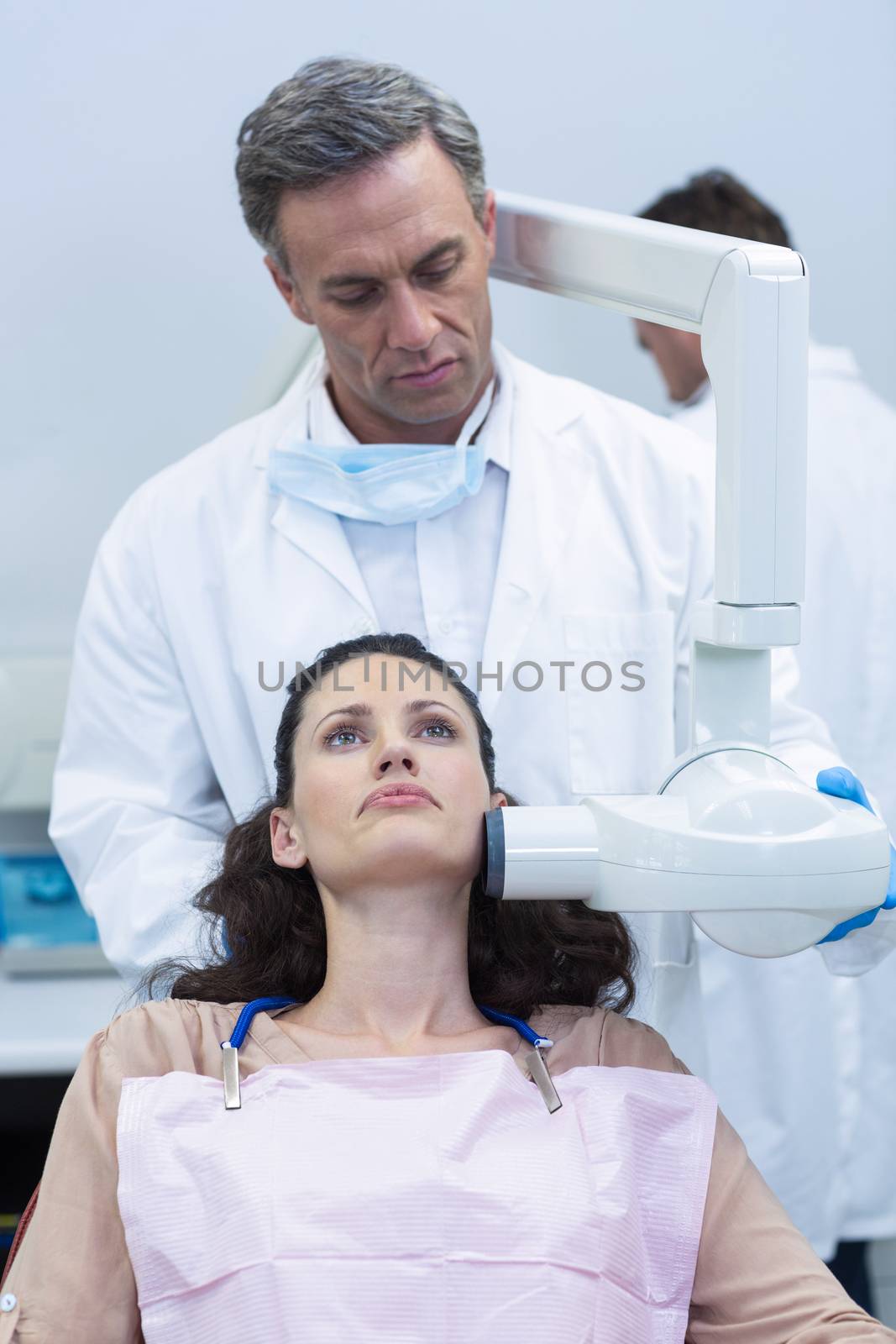 Dentist taking x-ray of patients teeth at dental clinic