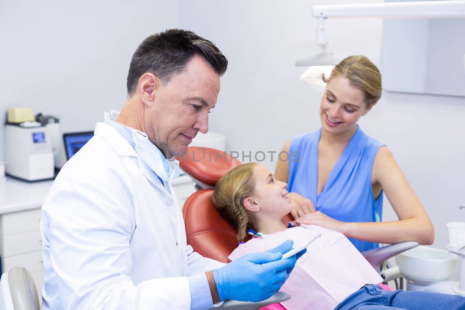 Dentist using digital tablet in dental clinic