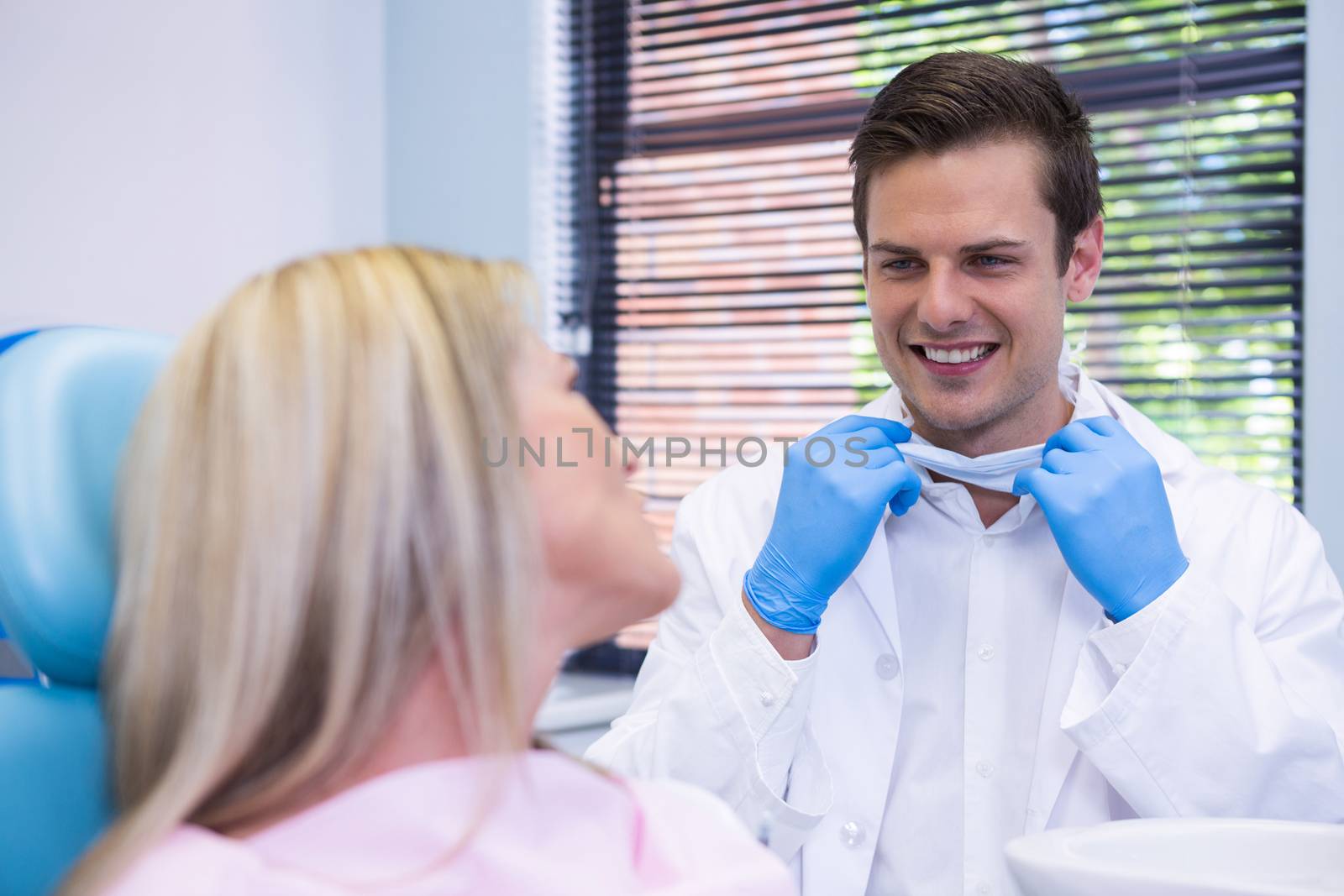 Happy patient talking with dentist by Wavebreakmedia