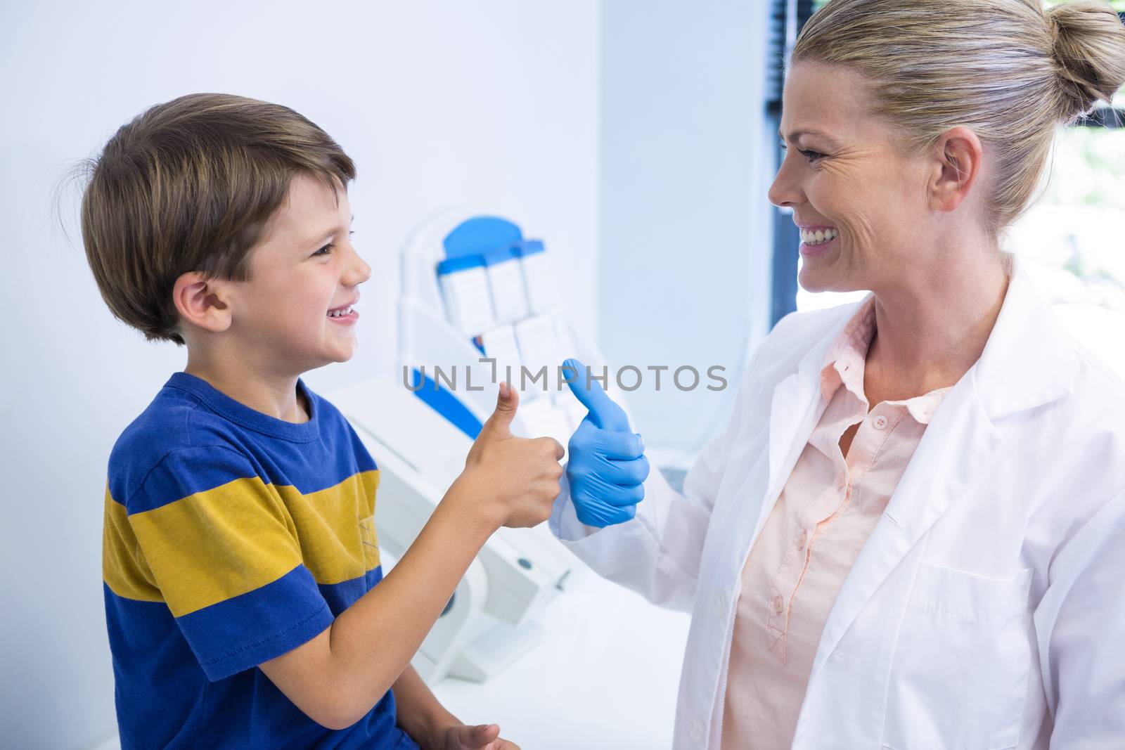 Happy dentist playing with boy by Wavebreakmedia