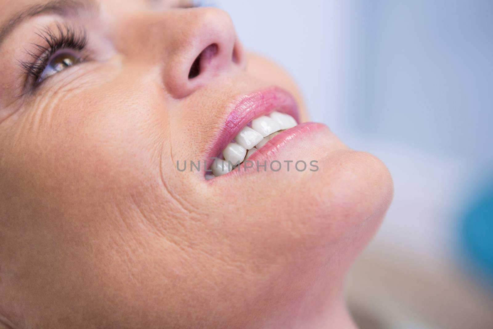Cropped image of beautiful woman smiling at dentist office