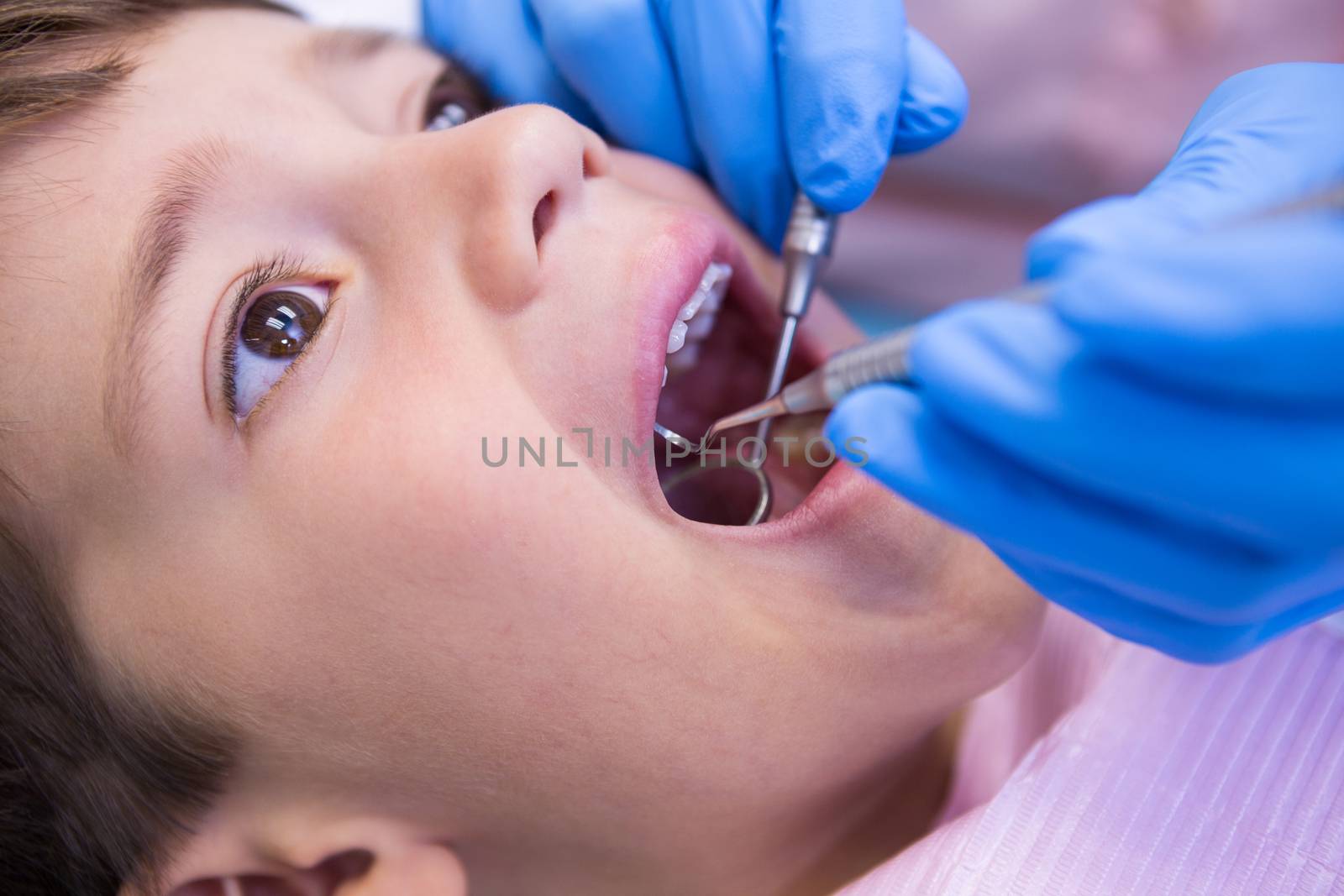 Close up of dentist examining patient at clinic