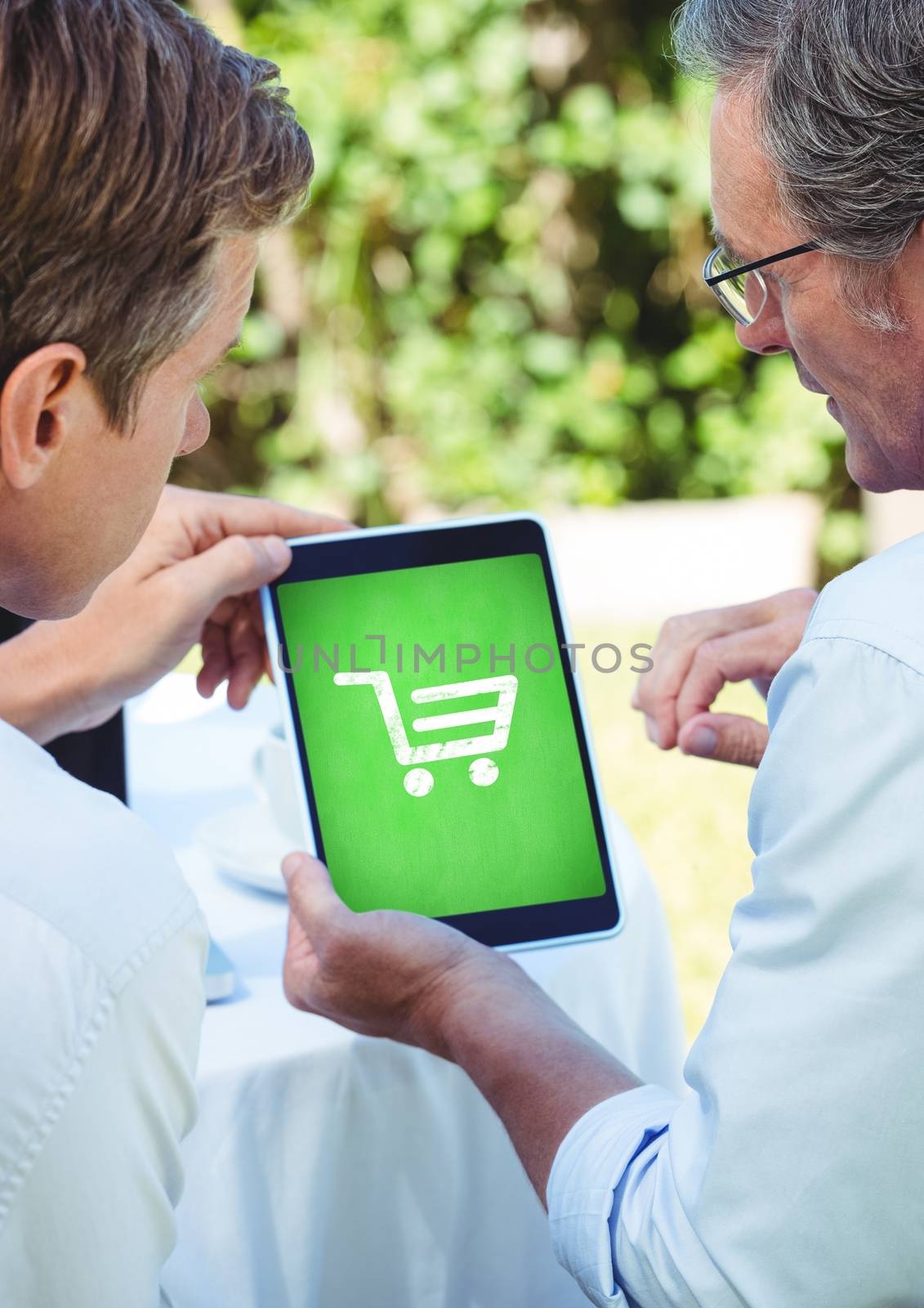 Digital composite of People using Tablet with Shopping trolley icon