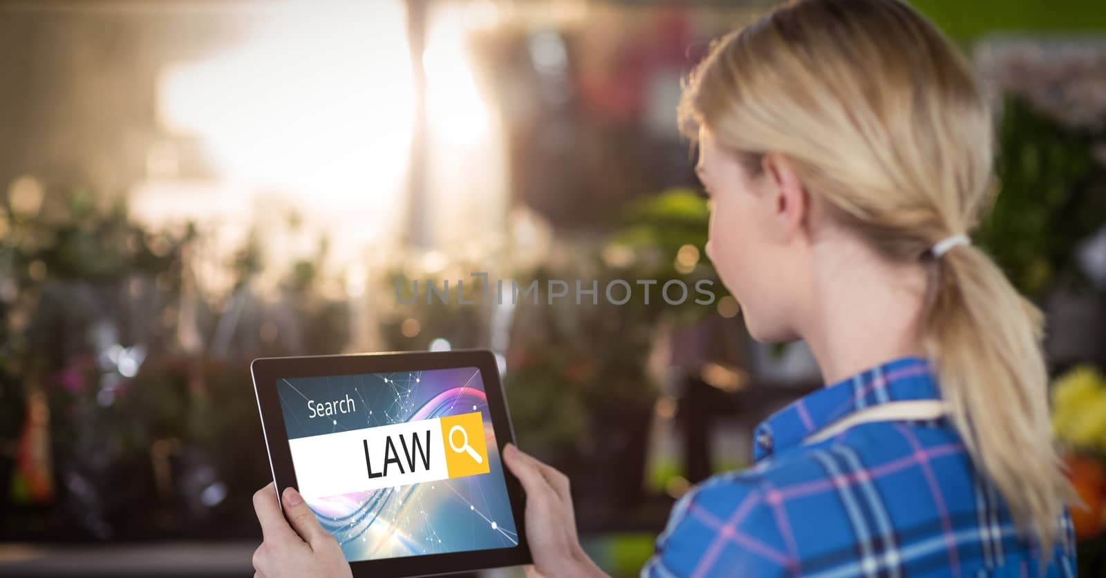 Female student searching for law studies on tablet PC by Wavebreakmedia