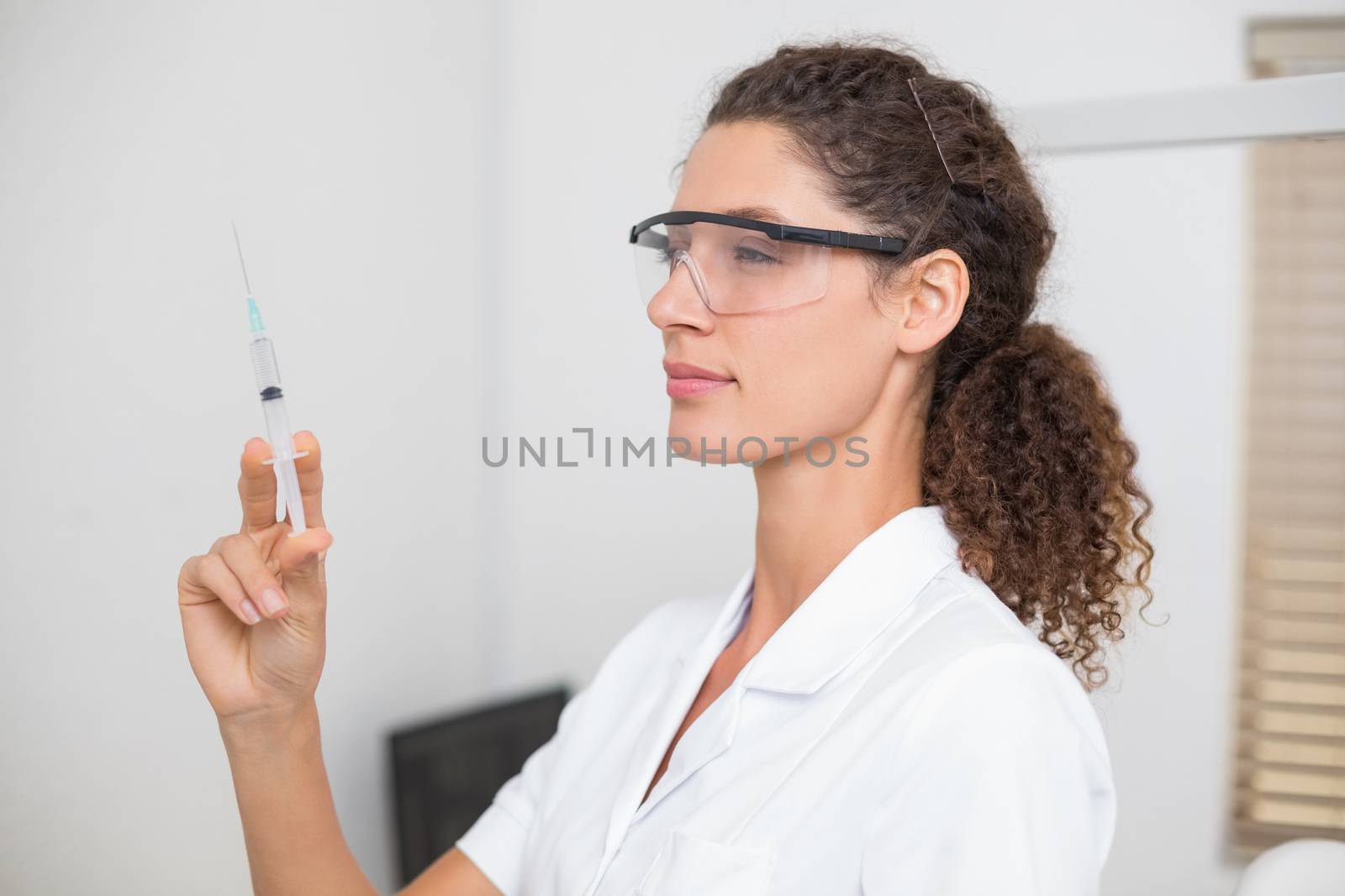 Dental assistant preparing an injection at the dental clinic