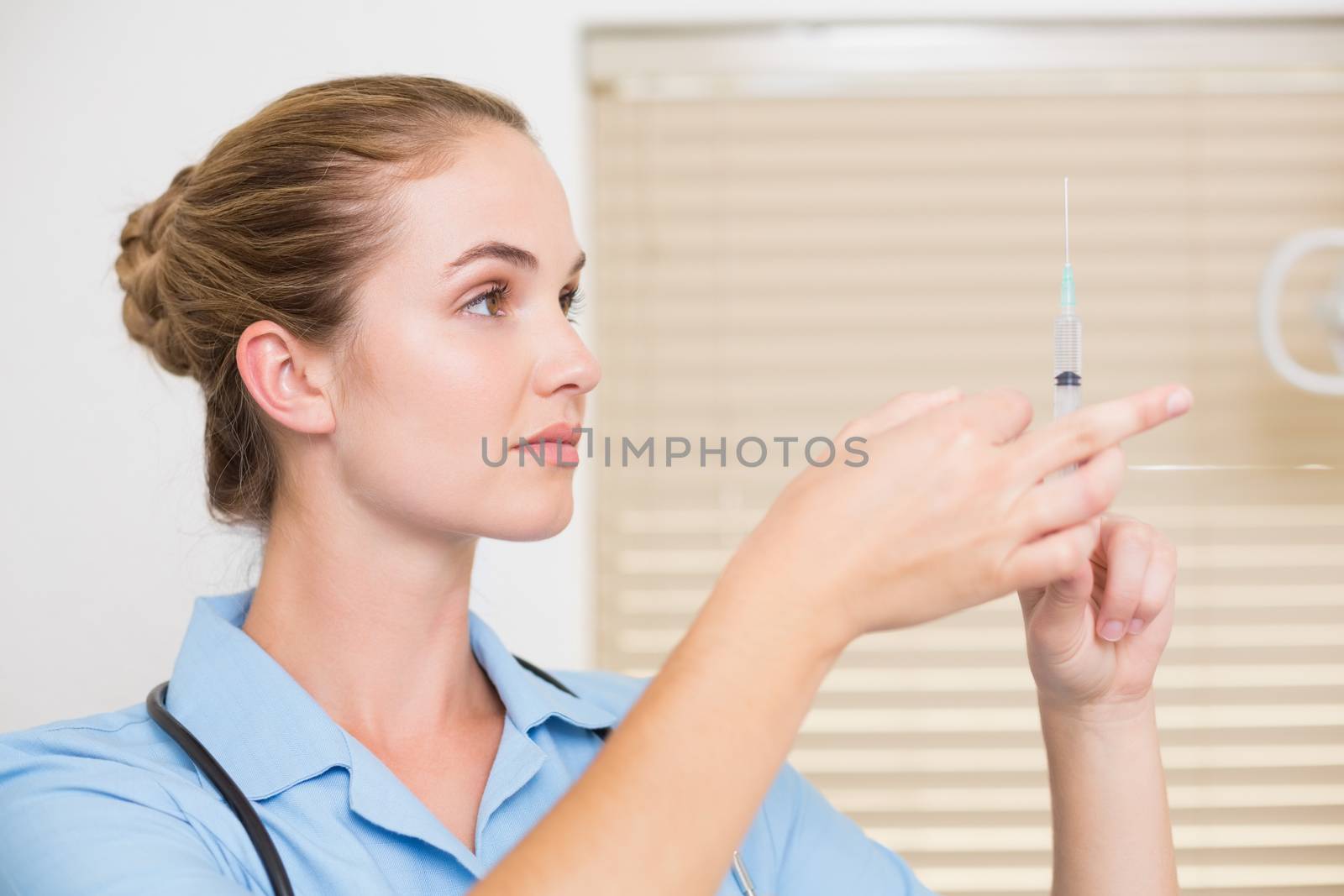 Dental assistant preparing an injection at the dental clinic