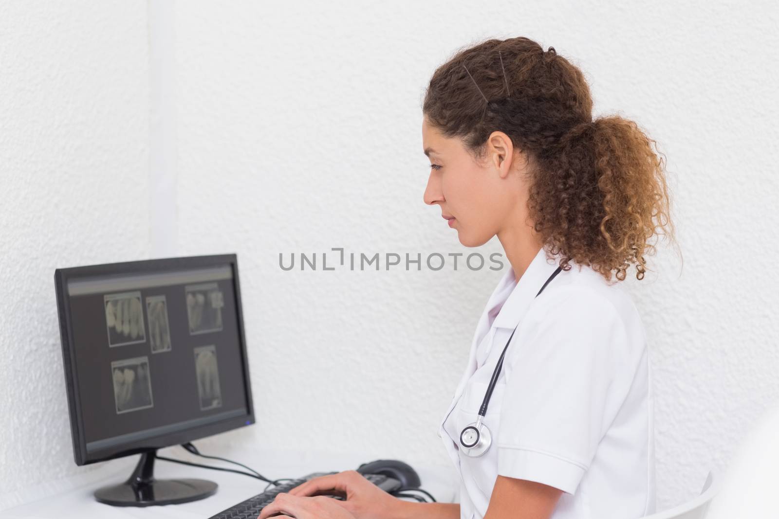 Dental assistant working on computer by Wavebreakmedia