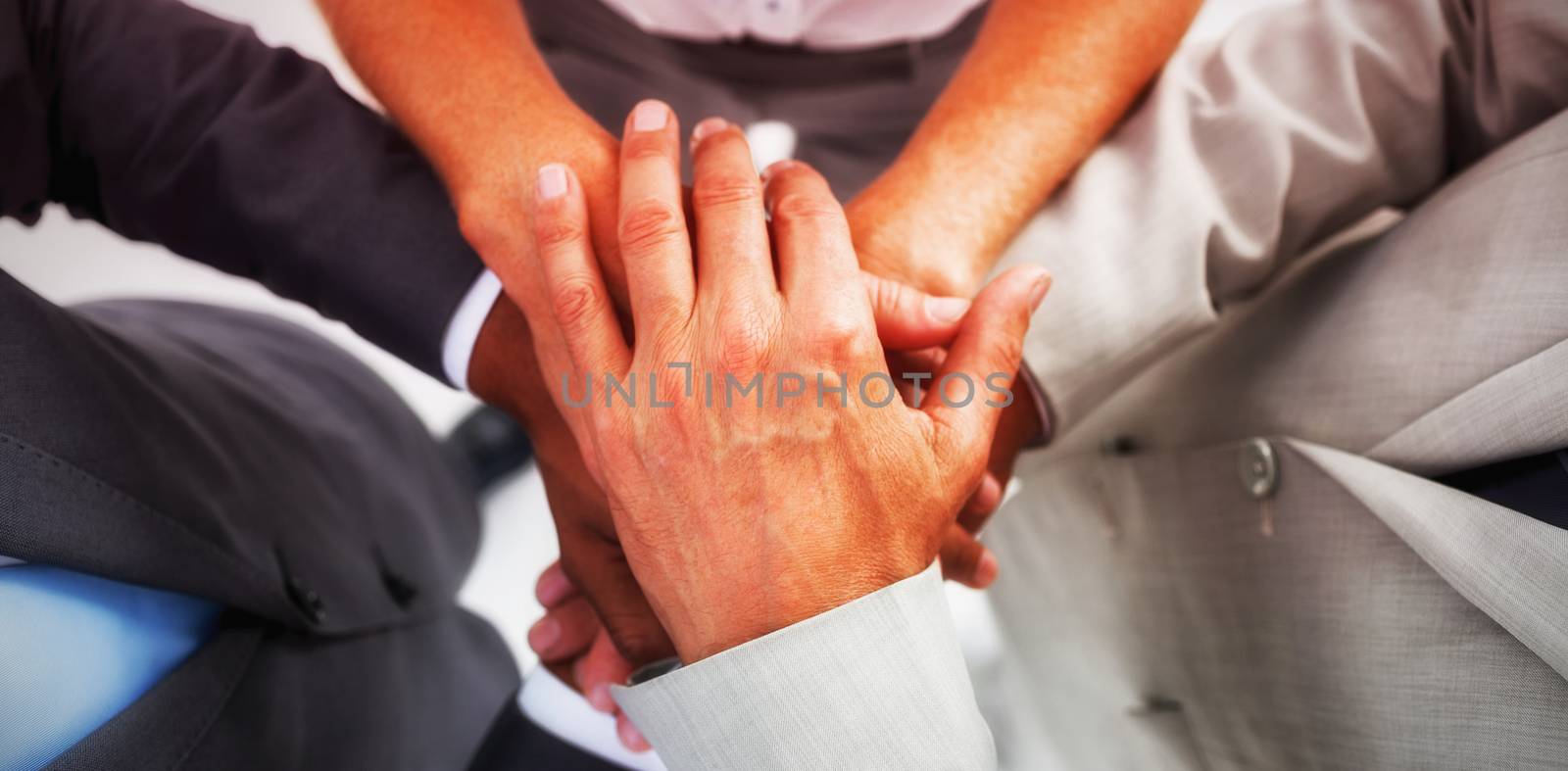 High angle view of business people gathering their hands together
