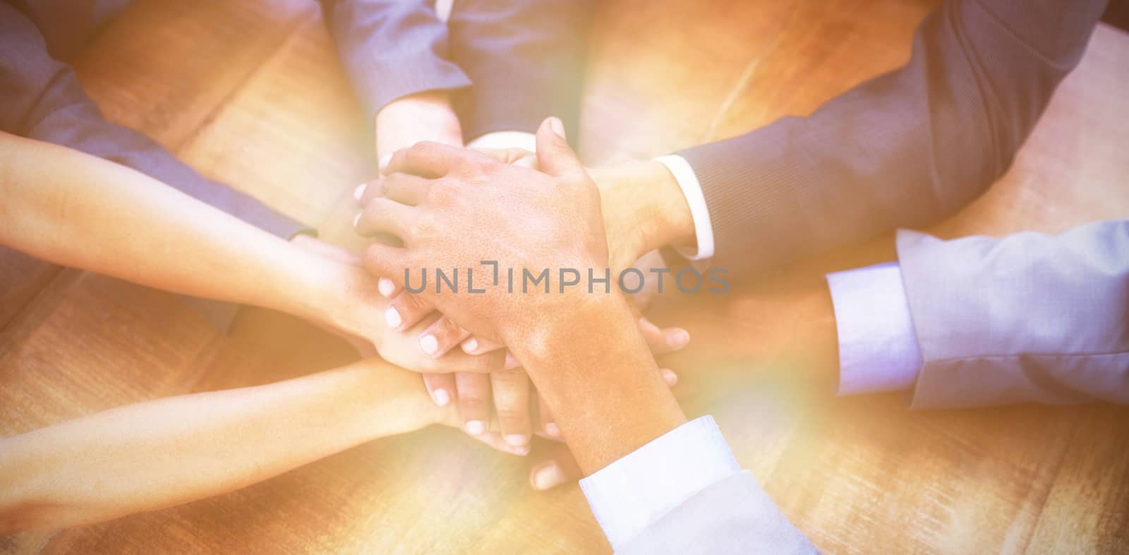 High angle view of business people stacking hands by Wavebreakmedia