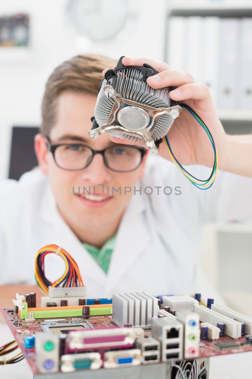 Smiling technician working on broken fan by Wavebreakmedia