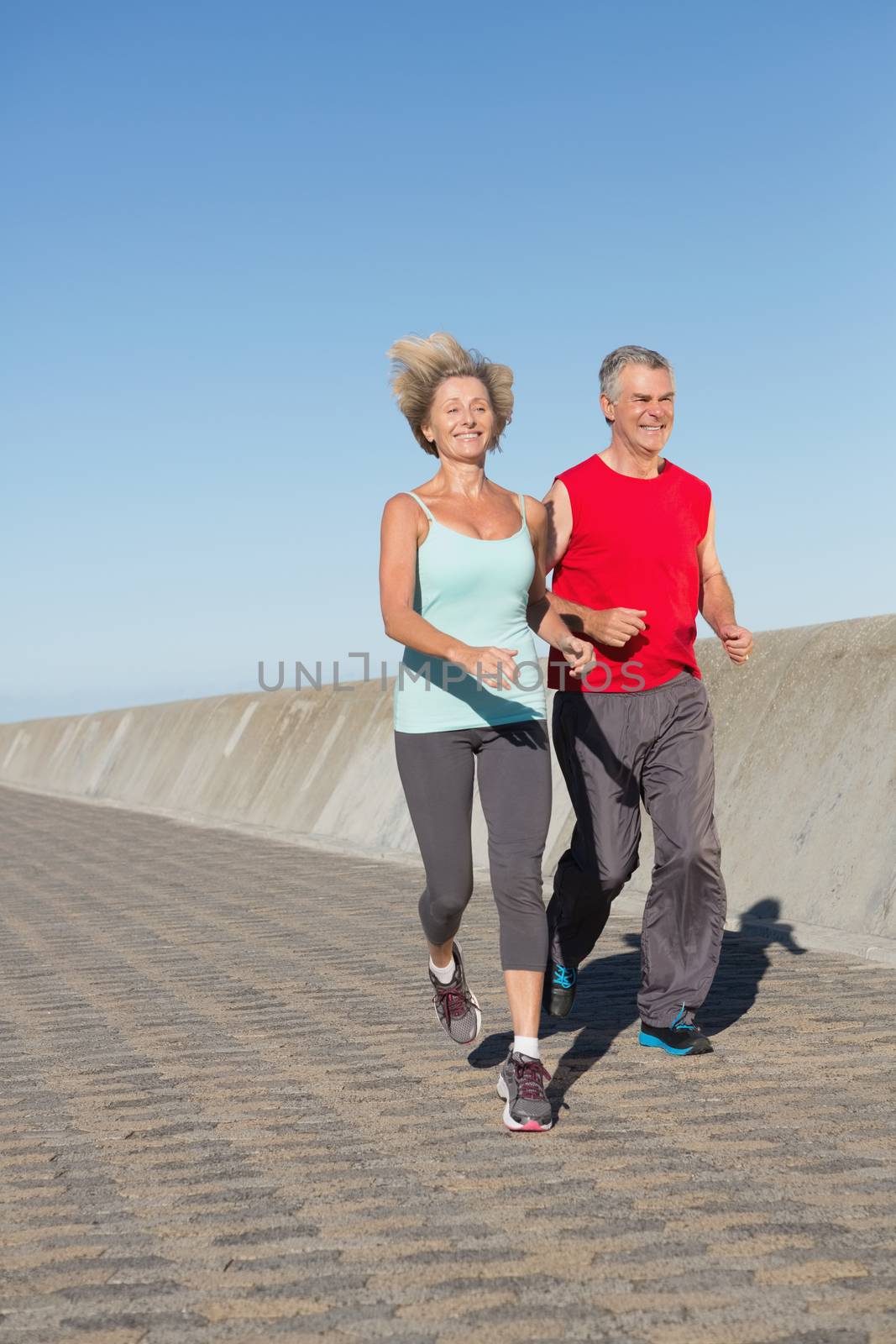 Active senior couple out for a jog on a sunny day