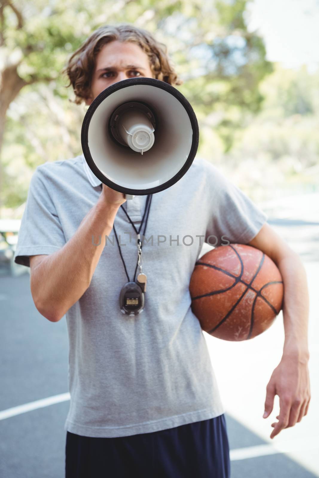 Male basketball coach using megaphone by Wavebreakmedia