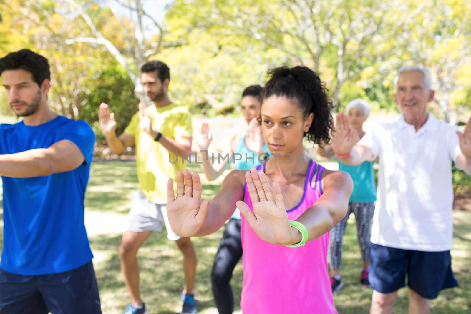 Group of people exercising in the park by Wavebreakmedia
