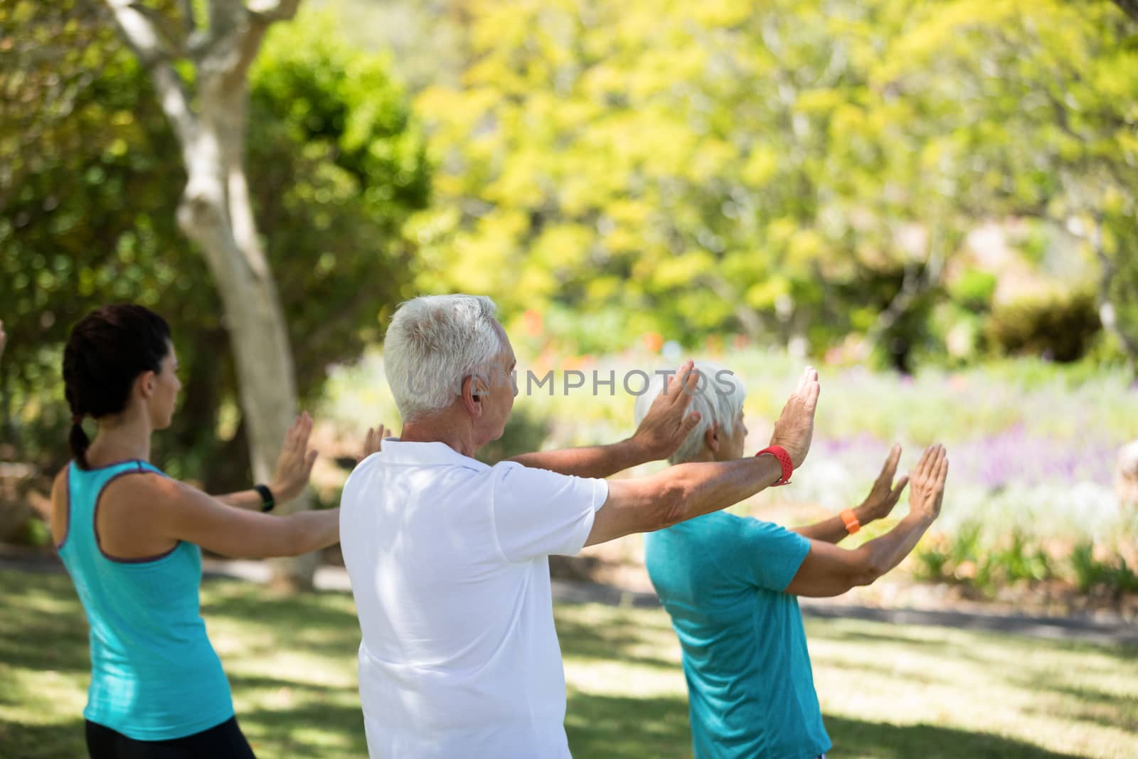 Group of people exercising in the park by Wavebreakmedia