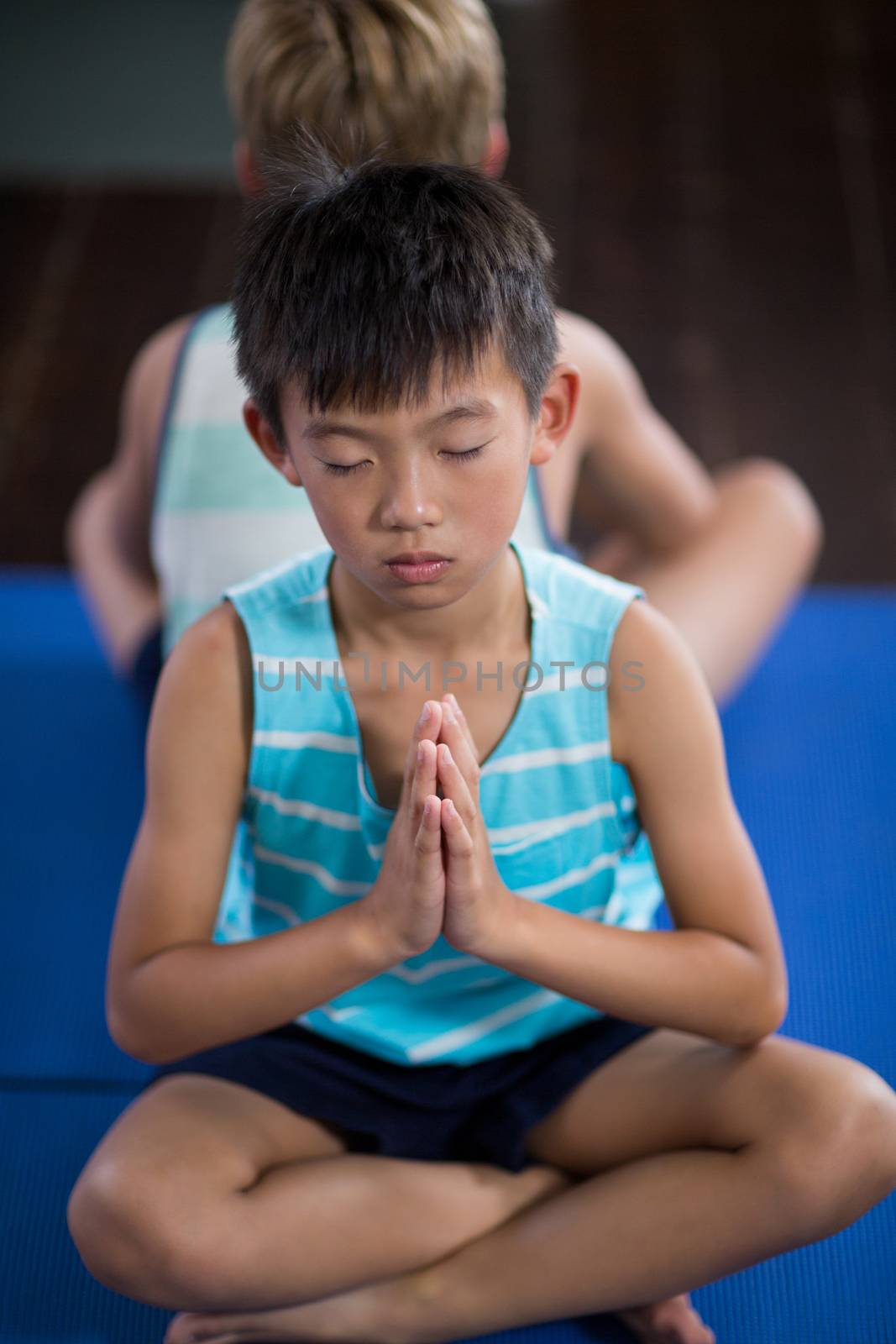 Close-up of boy performing yoga at home