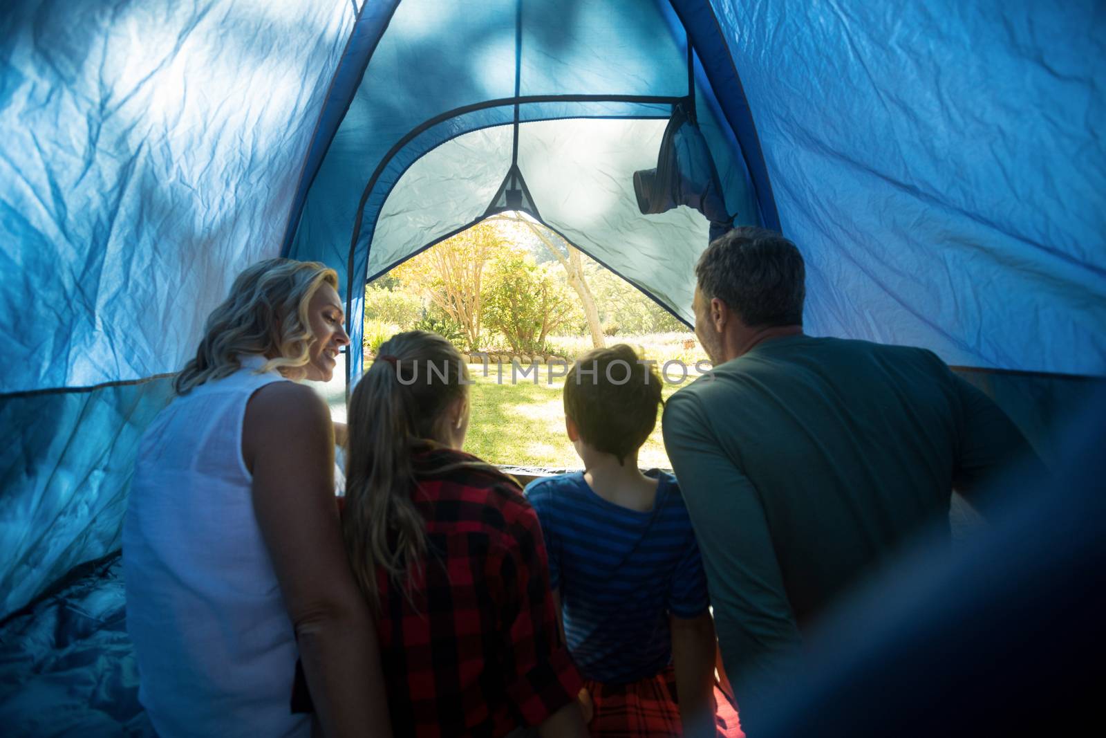 Family sitting in the tent by Wavebreakmedia