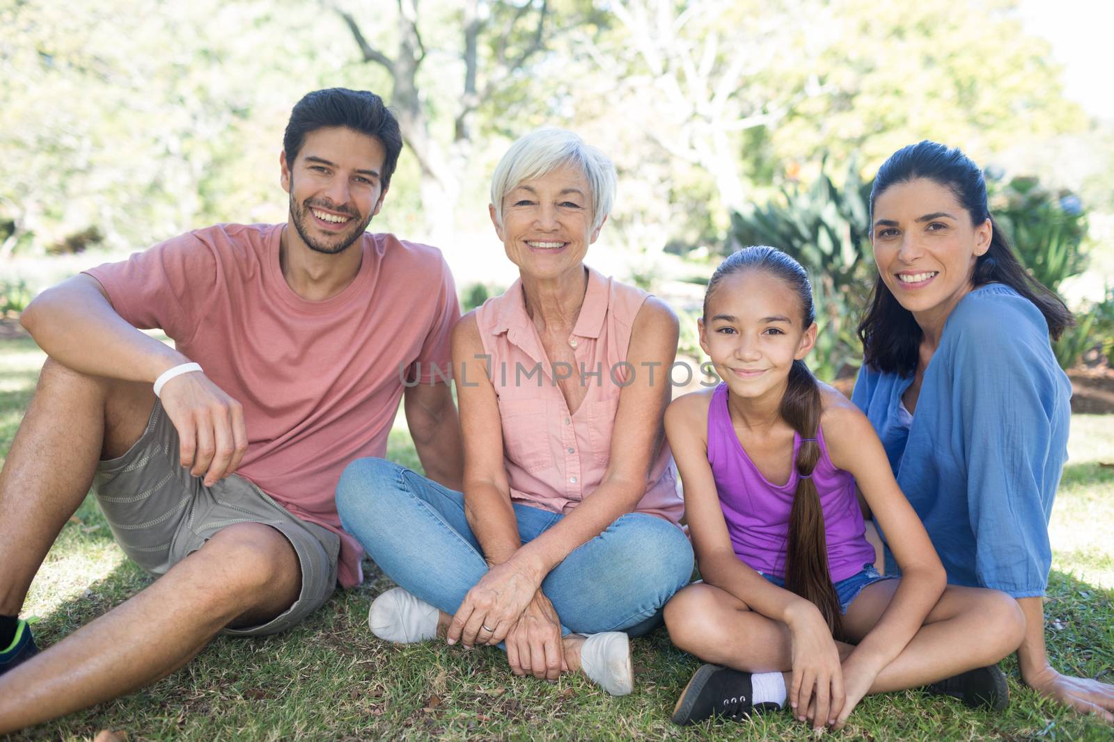 Portrait of happy family sitting in the park