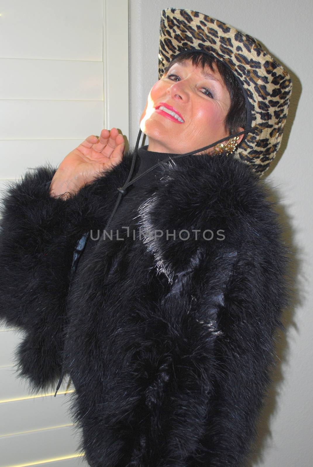 Mature female beauty expressions wearing a black outfit indoors.