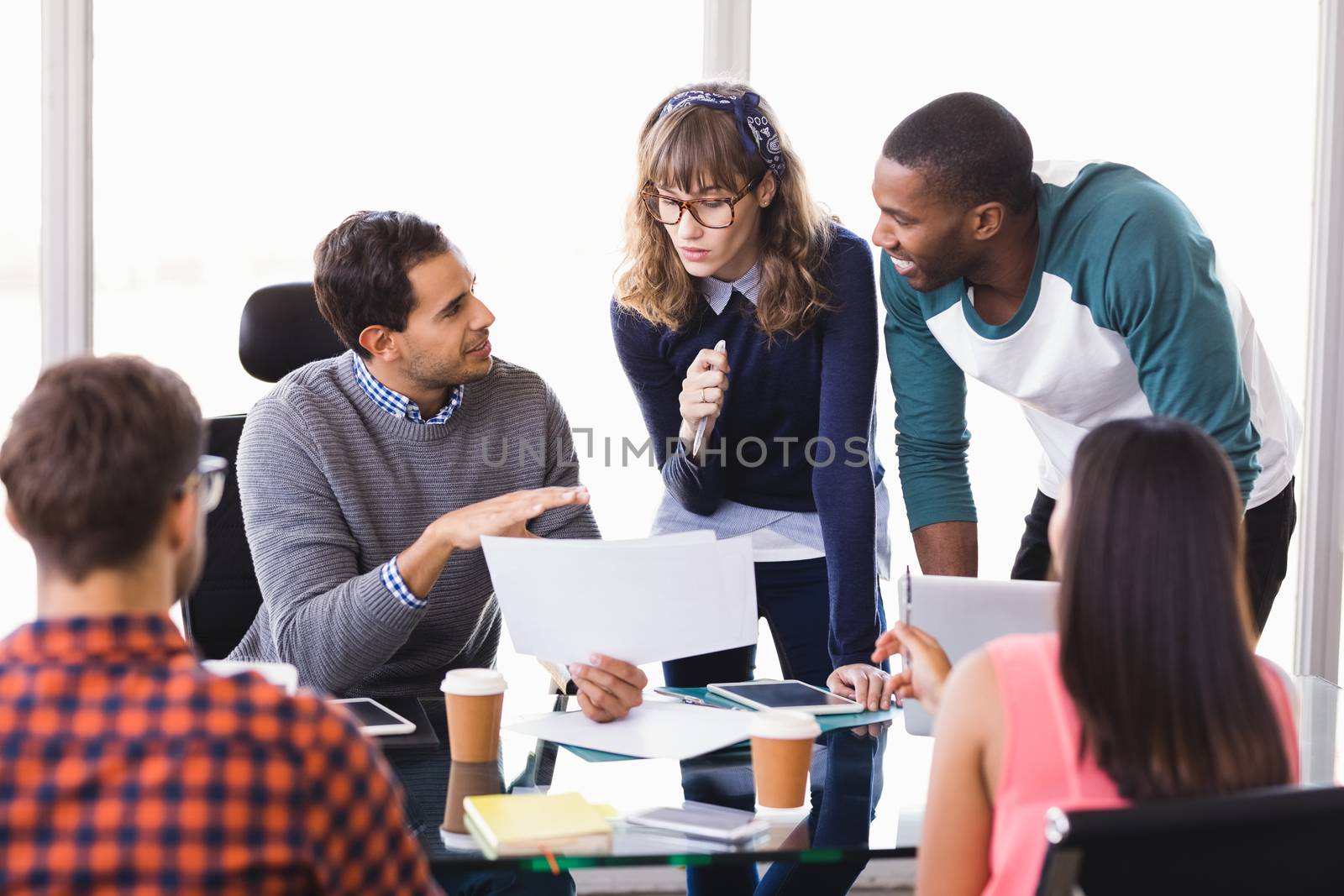 Business people discussing at desk in office