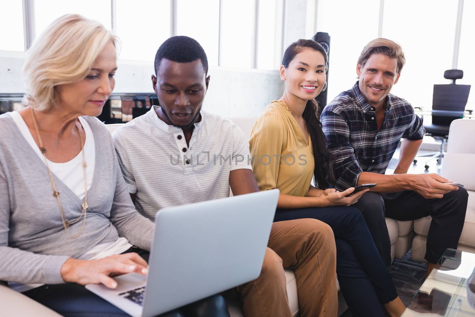 Business people sitting on sofa in office