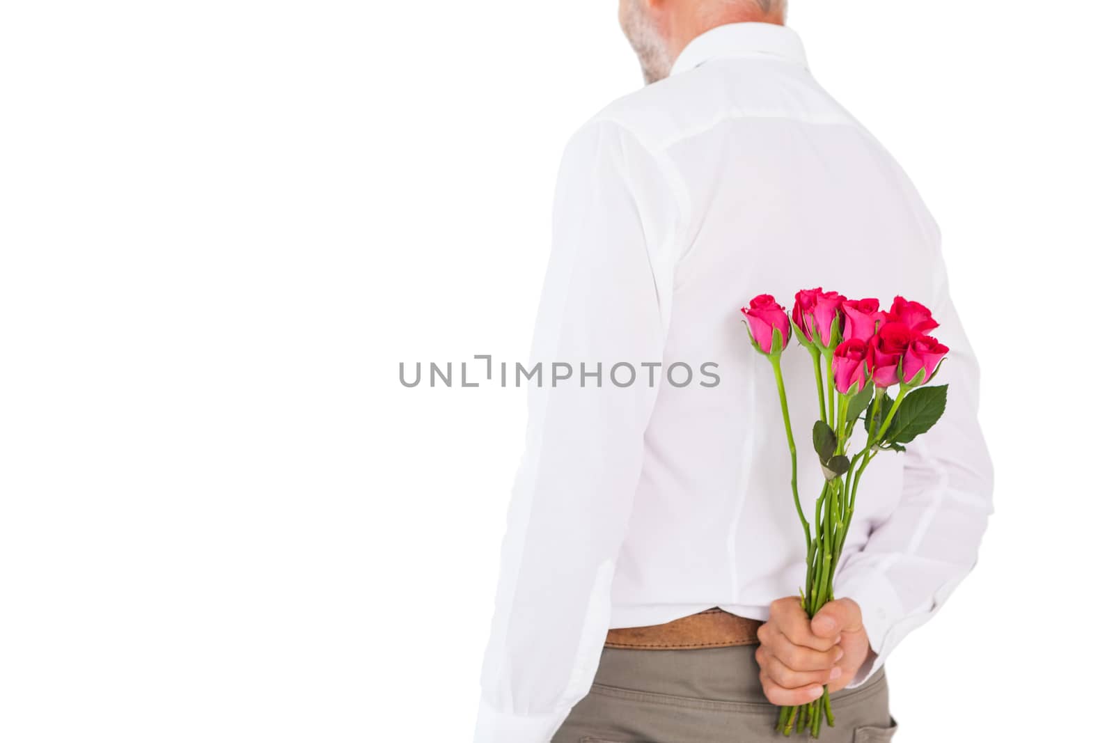 Man holding bouquet of roses behind back on white background