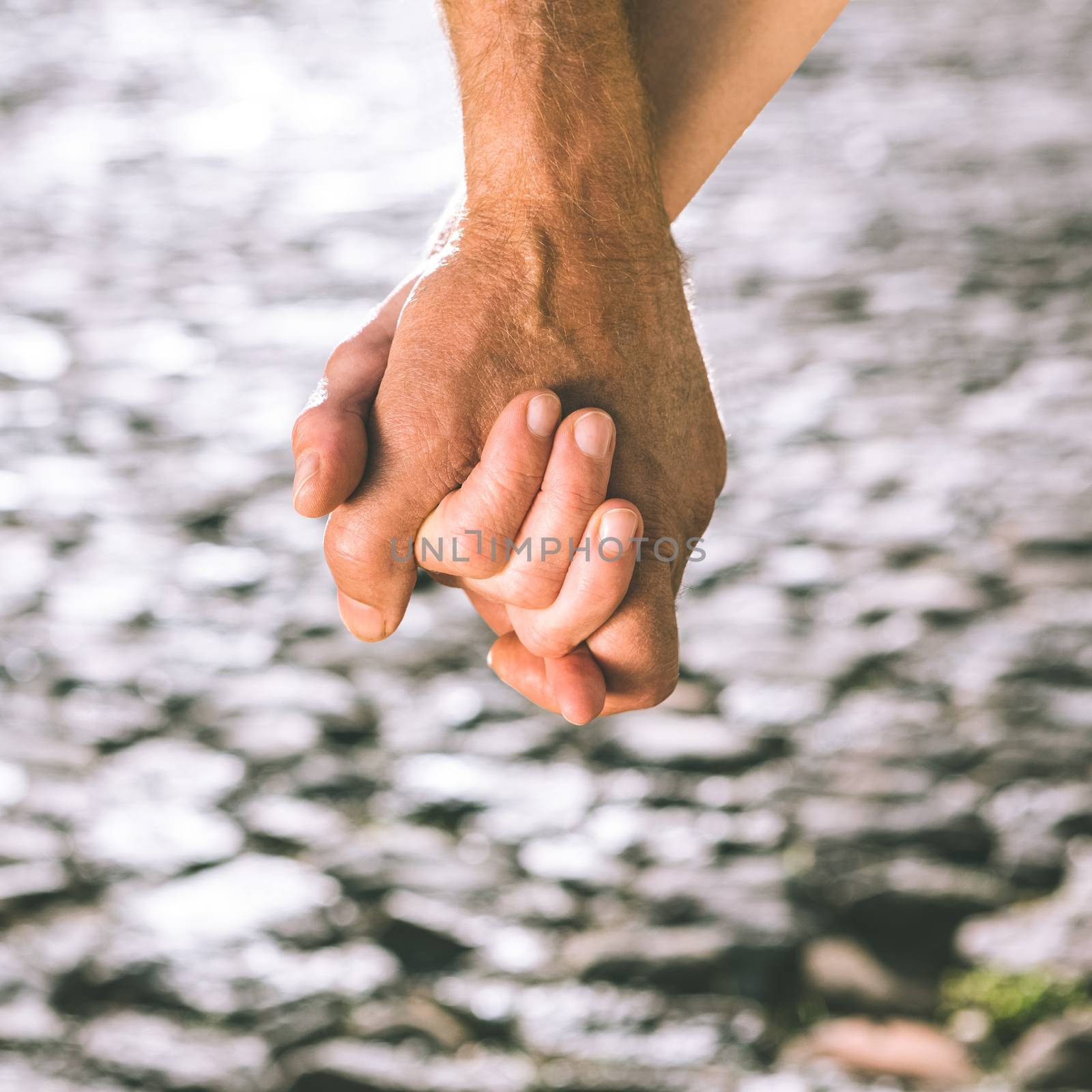 Happy senior couple holding hands on a sunny day