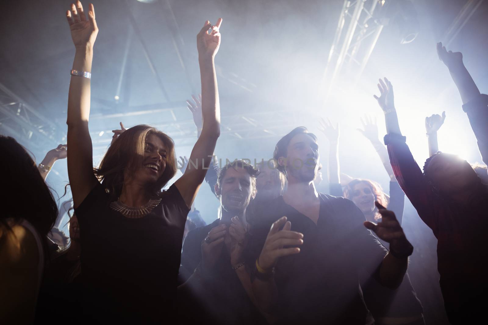 Happy people dancing at nightclub by Wavebreakmedia