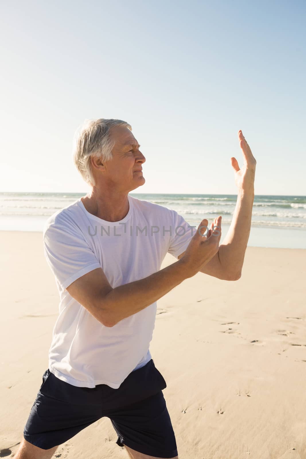 Active senior man practicing yoga by Wavebreakmedia