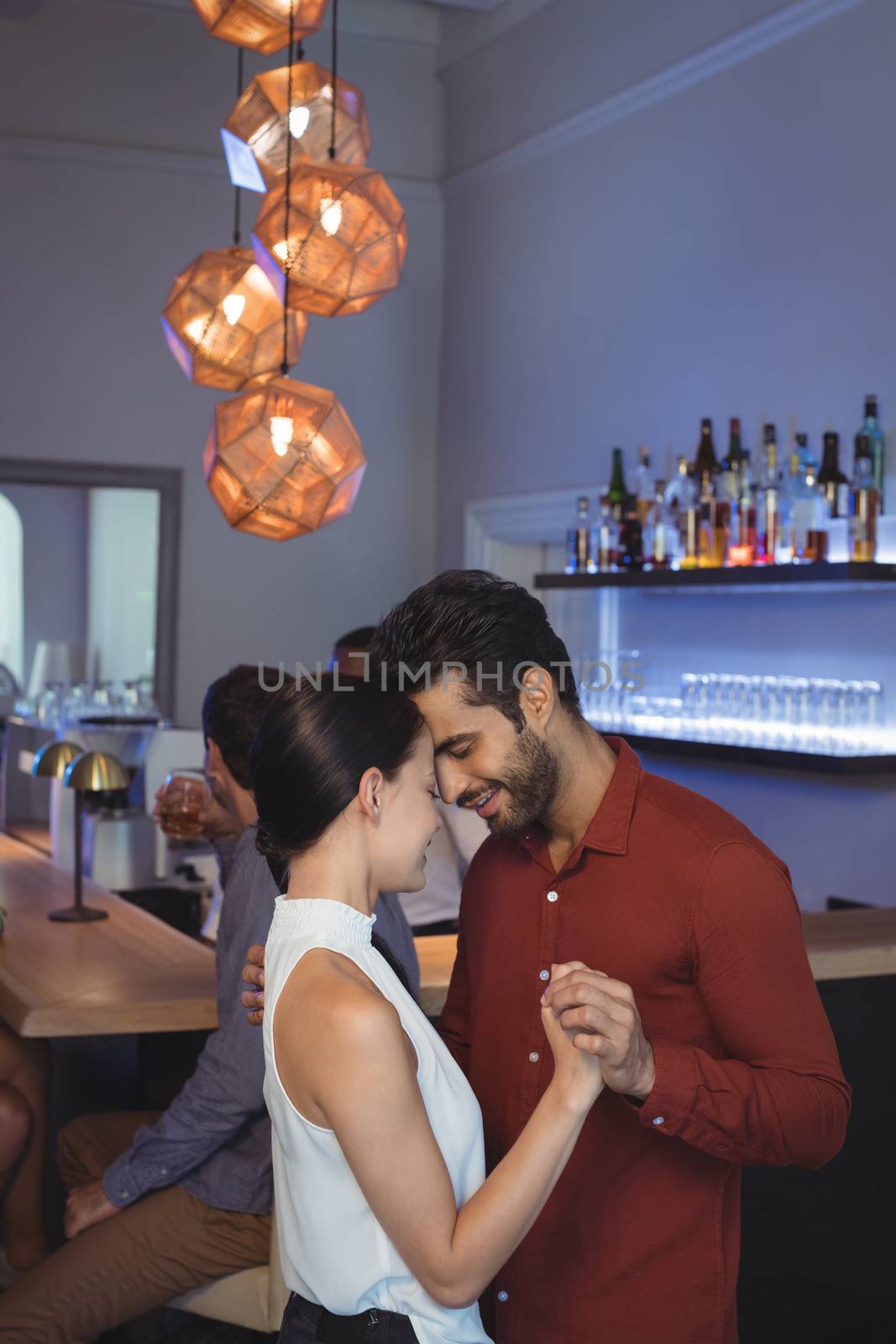 Romantic couple dancing together at bar restaurant